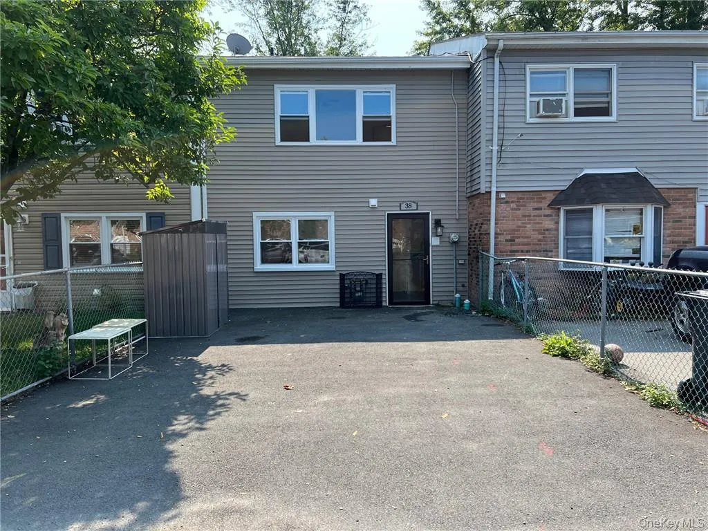 View of front facade with a wide driveway View of front facade with a wide driveway
