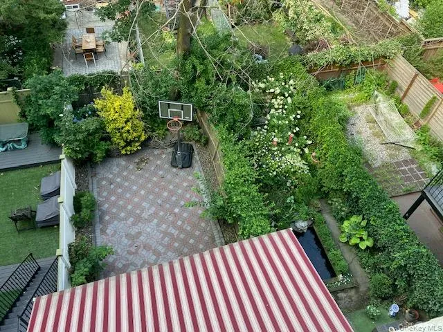 Backyard with covered terrace & basketball hoop Backyard with covered terrace & basketball hoop