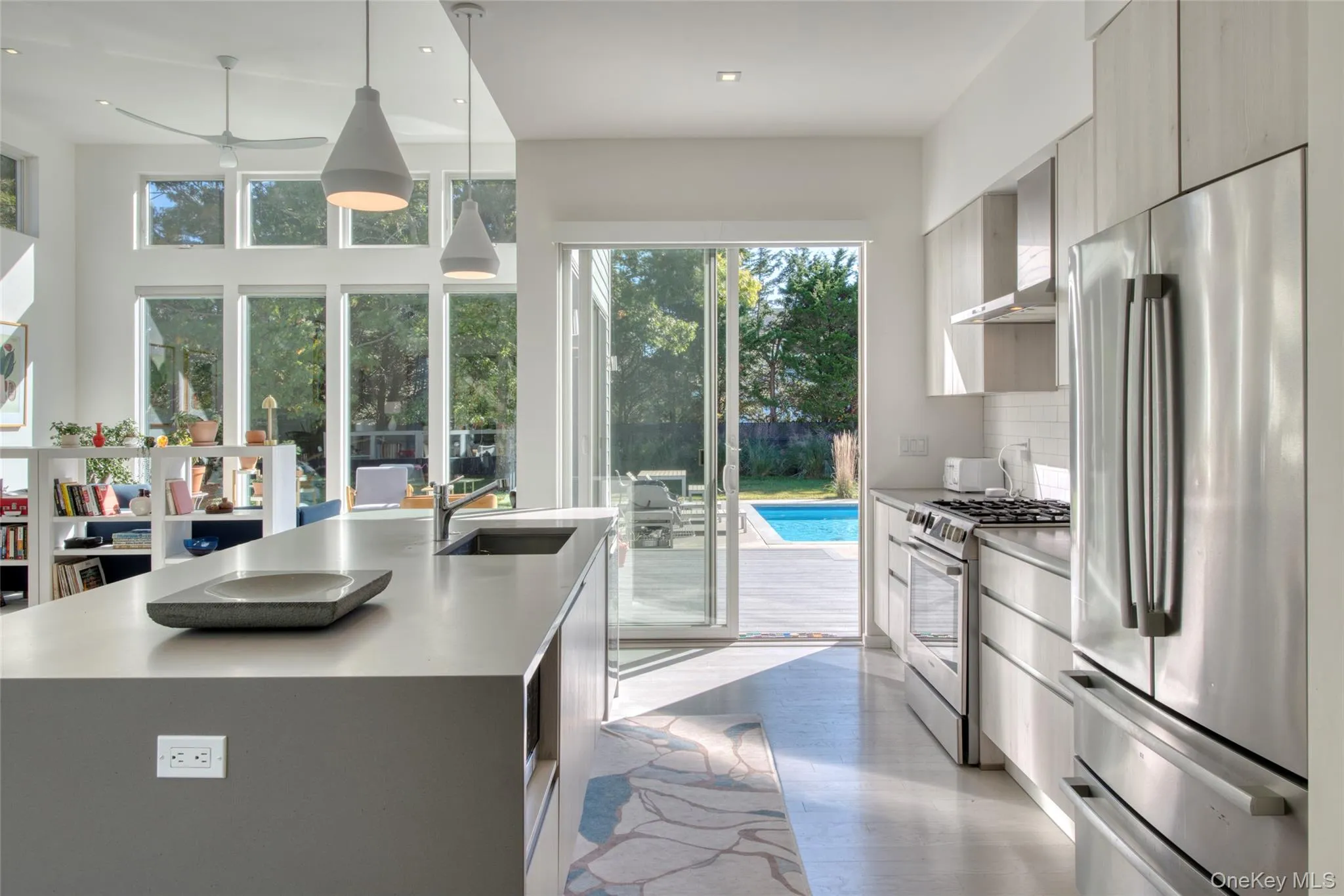 Kitchen with appliances with stainless steel finishes, plenty of natural light, pendant lighting, and an island with sink Kitchen with appliances with stainless steel finishes, plenty of natural light, pendant lighting, and an island with sink