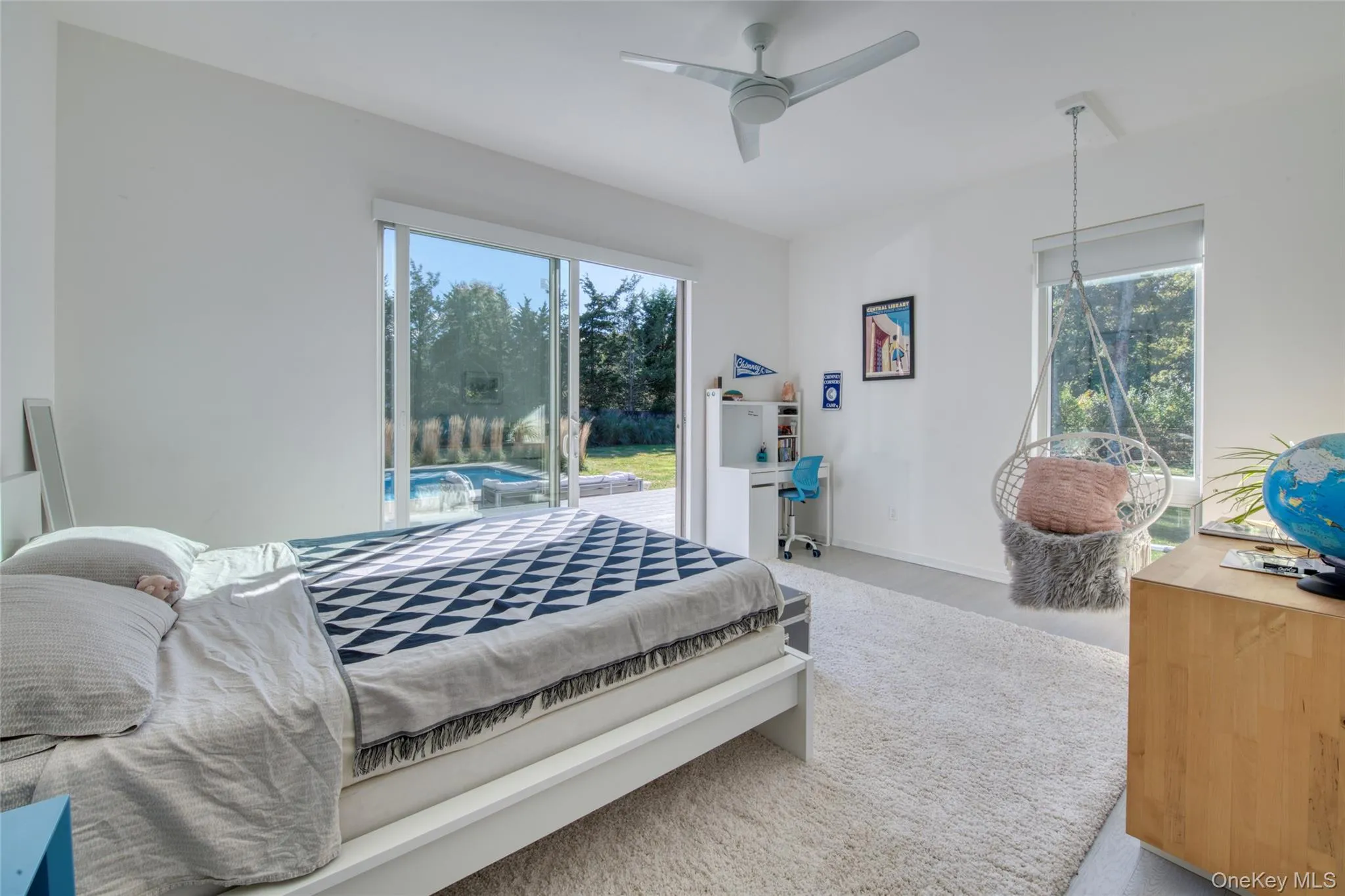 Carpeted bedroom with ceiling fan, access to outside, and multiple windows Carpeted bedroom with ceiling fan, access to outside, and multiple windows