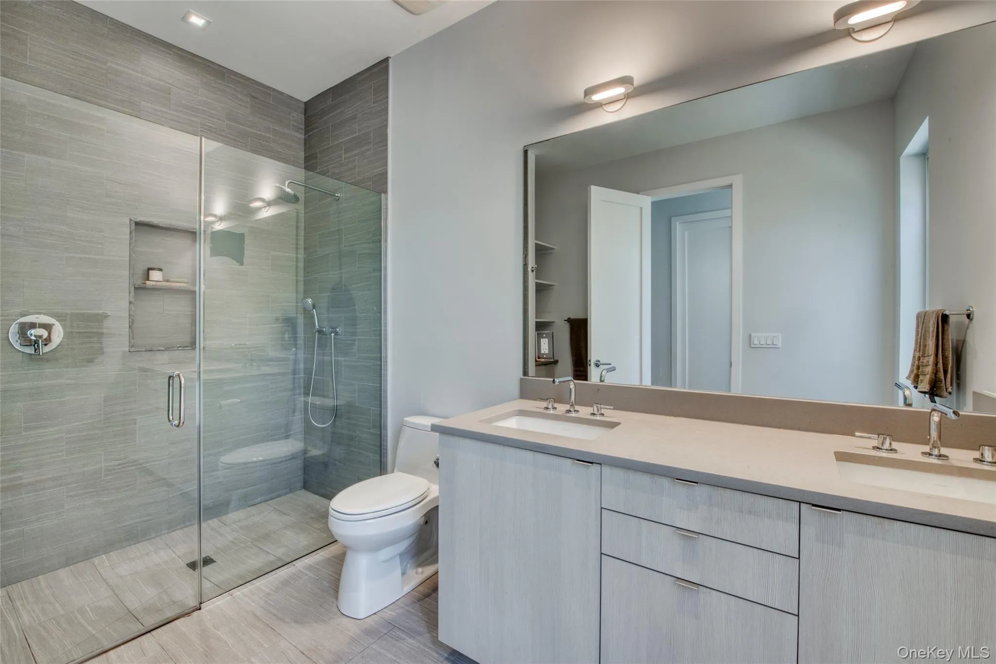 Bathroom with toilet, an enclosed shower, and vanity Bathroom with toilet, an enclosed shower, and vanity