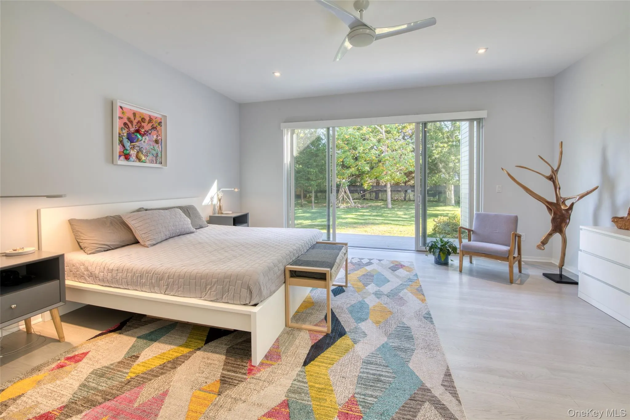 Bedroom with access to exterior, light wood-type flooring, and ceiling fan Bedroom with access to exterior, light wood-type flooring, and ceiling fan