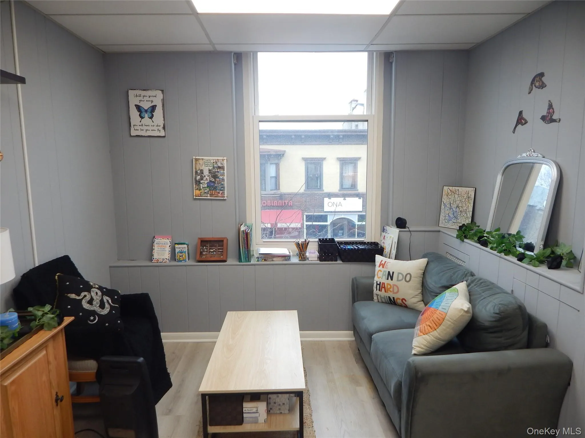 Office with a paneled ceiling and light hardwood / wood-style floors Office with a paneled ceiling and light hardwood / wood-style floors