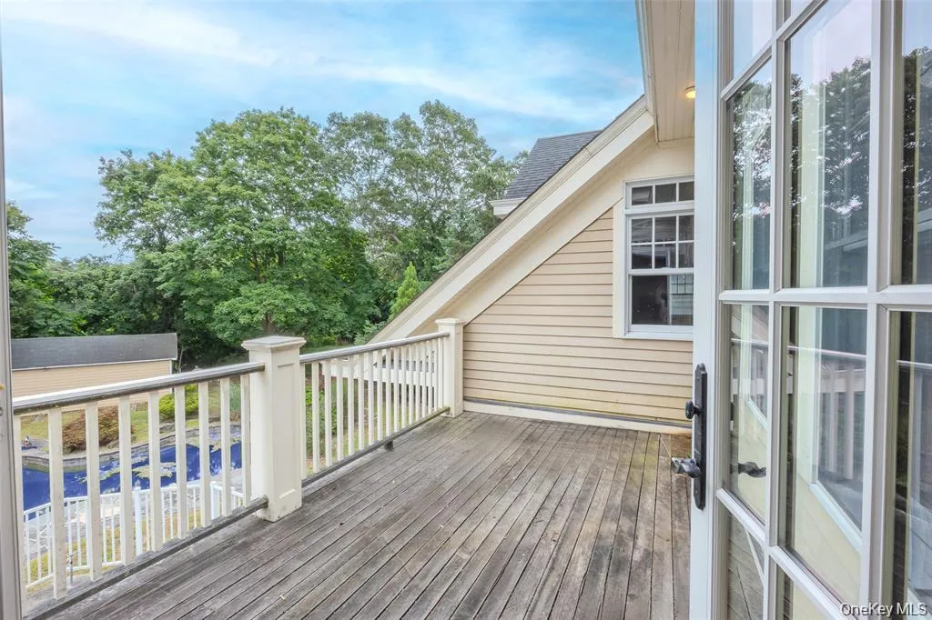 Wooden terrace with an outdoor structure and view of wooded area Wooden terrace with an outdoor structure and view of wooded area