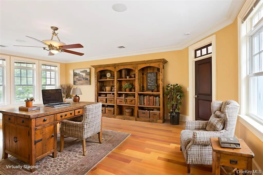 Office area featuring ornamental molding, light wood-style floors, and ceiling fan Office area featuring ornamental molding, light wood-style floors, and ceiling fan