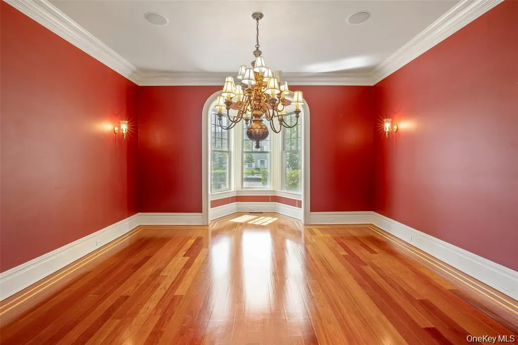 Unfurnished dining area with light wood finished floors, a chandelier, and ornamental molding Unfurnished dining area with light wood finished floors, a chandelier, and ornamental molding