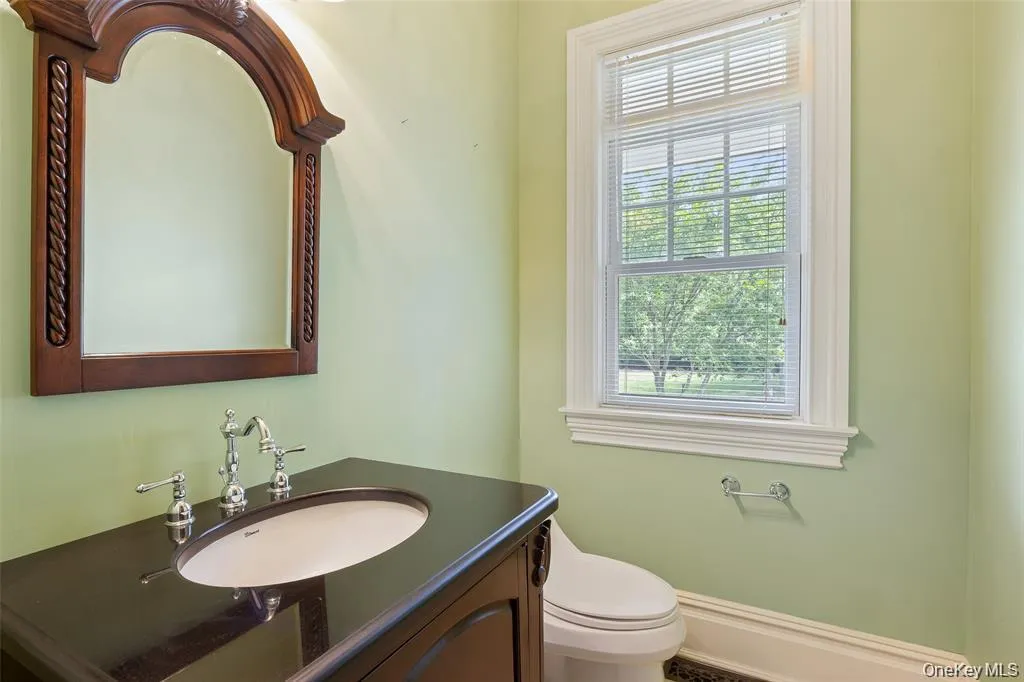 Bathroom featuring toilet and vanity Bathroom featuring toilet and vanity