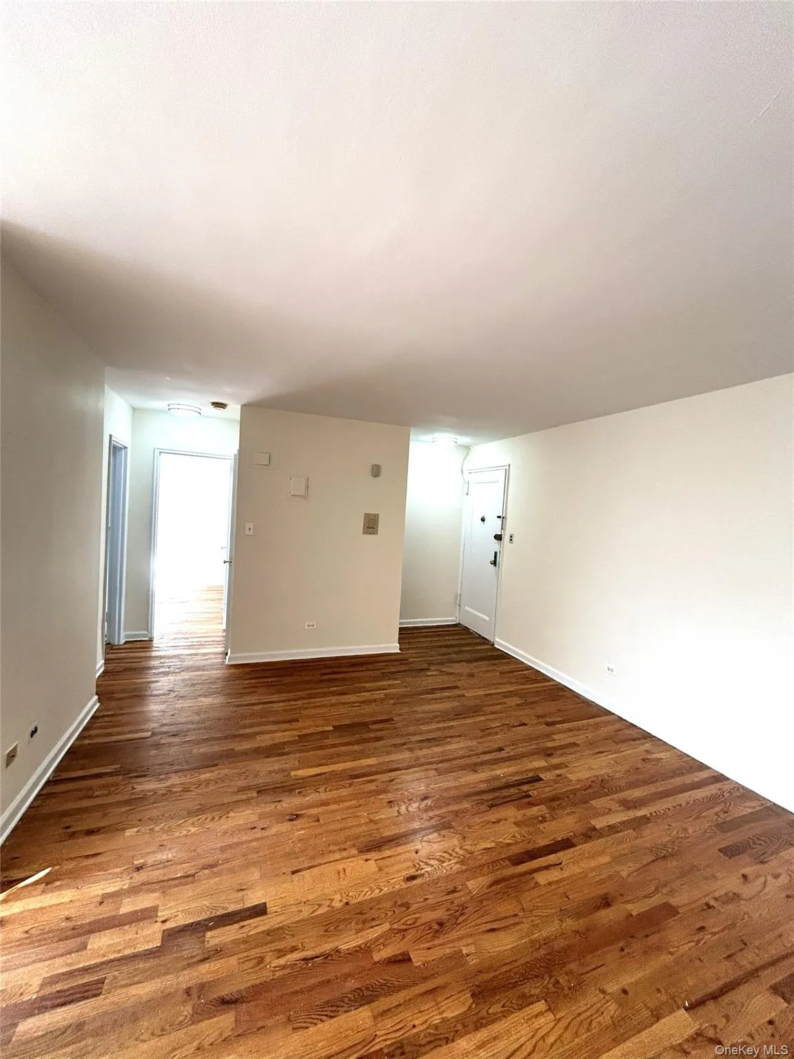 Spare room with wood finished floors and baseboards Spare room with wood finished floors and baseboards