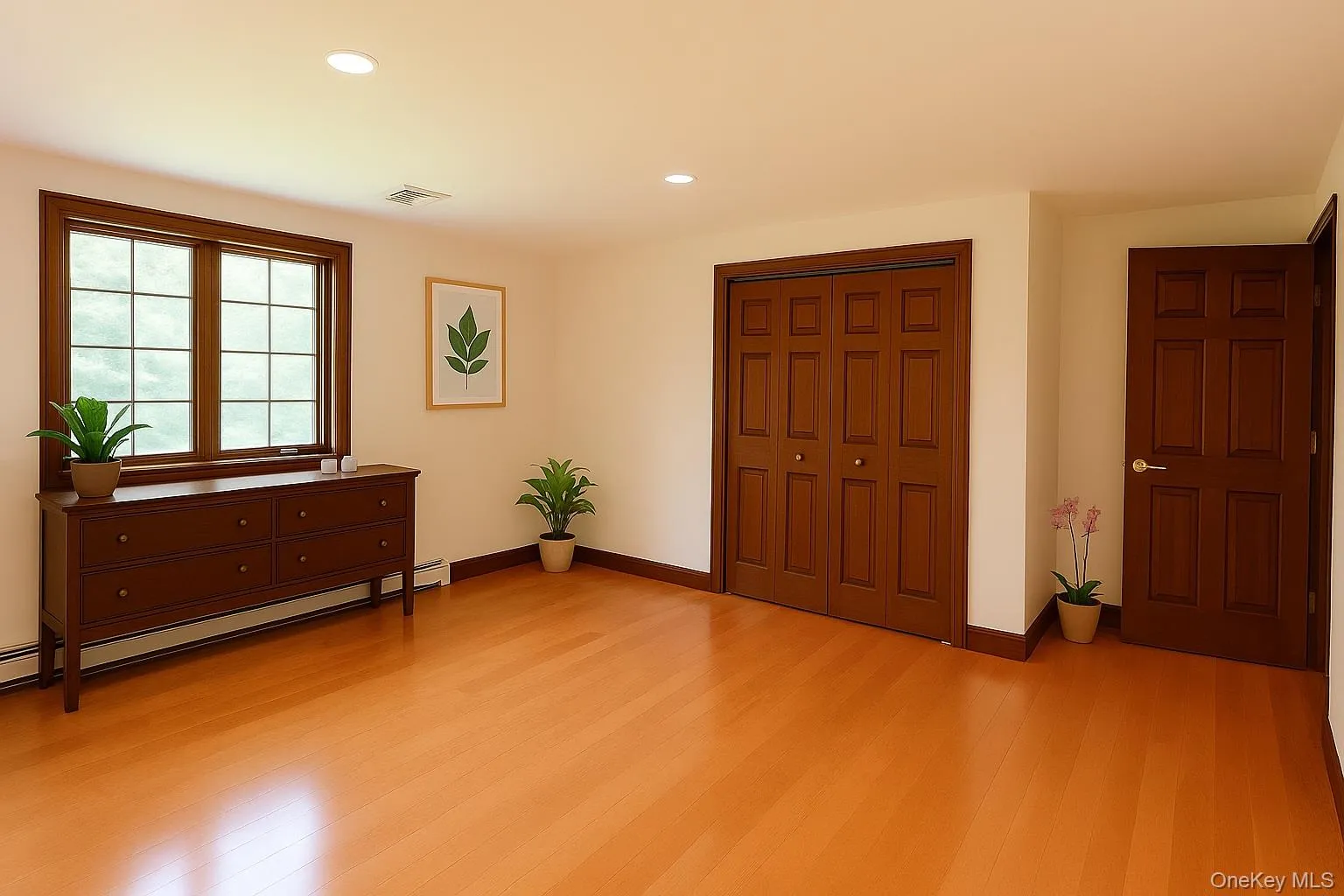 Bedroom featuring recessed lighting, light wood-type flooring, a closet, and a baseboard heating unit Bedroom featuring recessed lighting, light wood-type flooring, a closet, and a baseboard heating unit