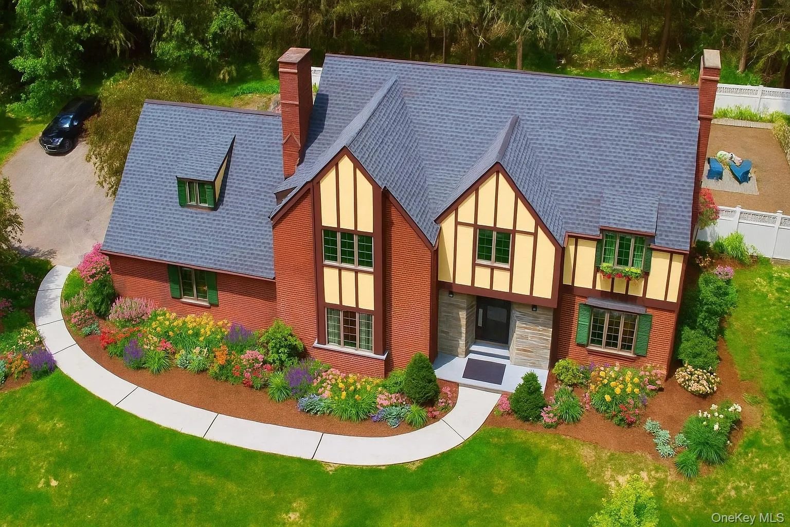 View of front facade featuring a chimney, stone siding, and roof with shingles View of front facade featuring a chimney, stone siding, and roof with shingles
