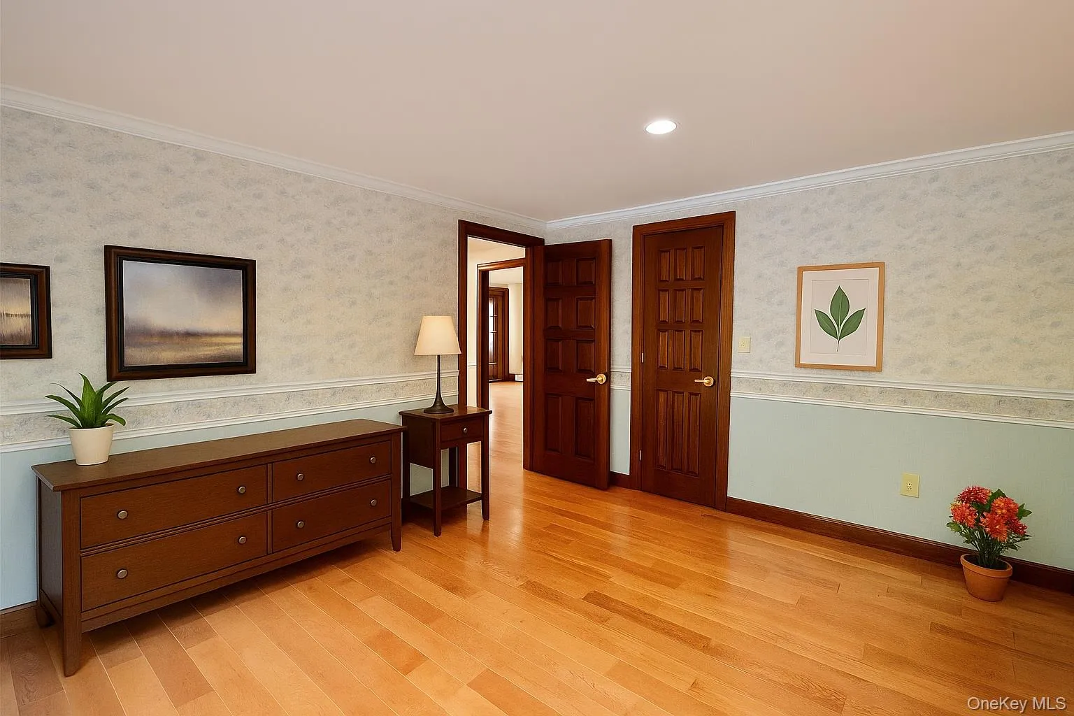Sitting room featuring light wood finished floors, crown molding, recessed lighting, a wainscoted wall, and wallpapered walls Sitting room featuring light wood finished floors, crown molding, recessed lighting, a wainscoted wall, and wallpapered walls