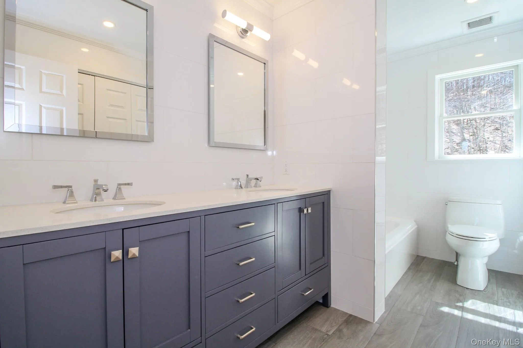 Guest bathroom with double sinks & laundry Guest bathroom with double sinks & laundry