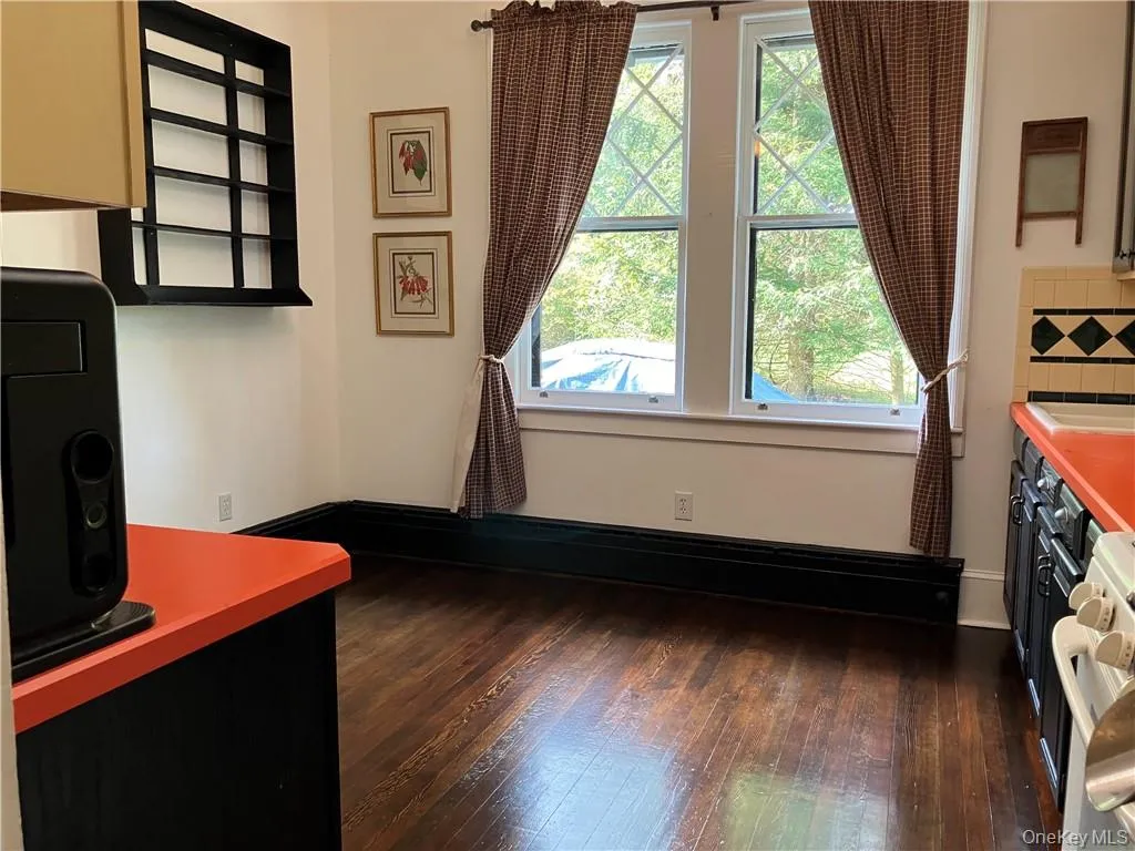 Office area featuring sink and dark hardwood / wood-style flooring Office area featuring sink and dark hardwood / wood-style flooring