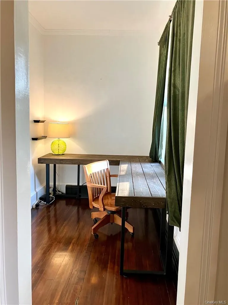 Office area with crown molding and dark wood-type flooring Office area with crown molding and dark wood-type flooring