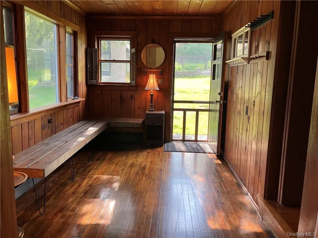 Unfurnished sunroom with wood ceiling and a healthy amount of sunlight Unfurnished sunroom with wood ceiling and a healthy amount of sunlight
