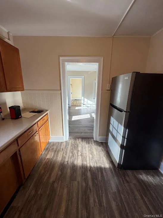 View from kitchen into living room and entryway View from kitchen into living room and entryway