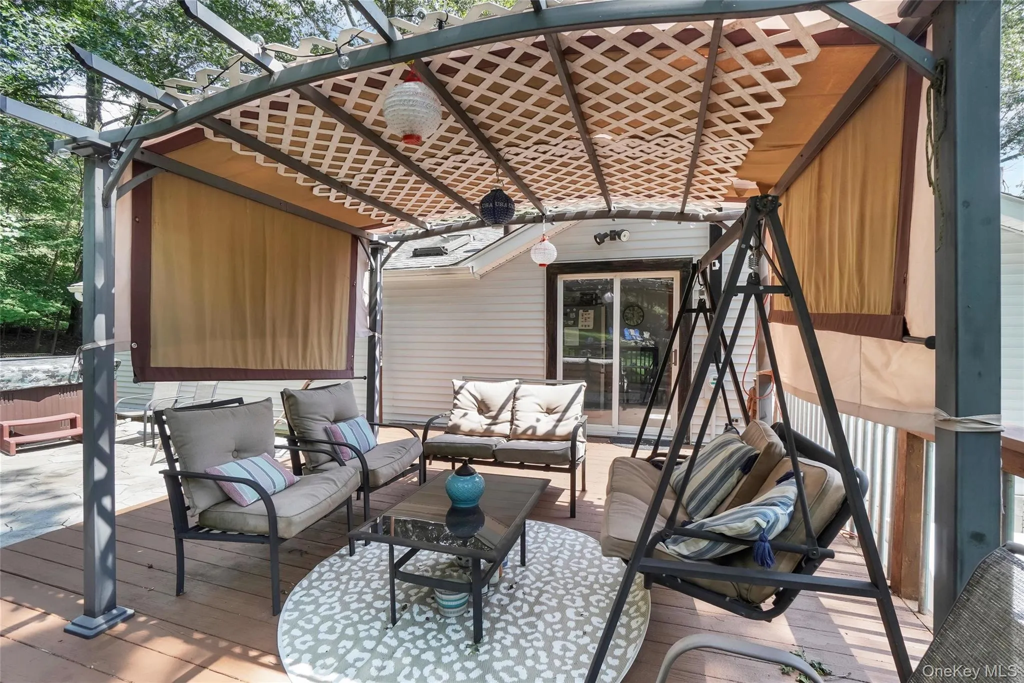 Wooden terrace featuring an outdoor hangout area and a pergola Wooden terrace featuring an outdoor hangout area and a pergola