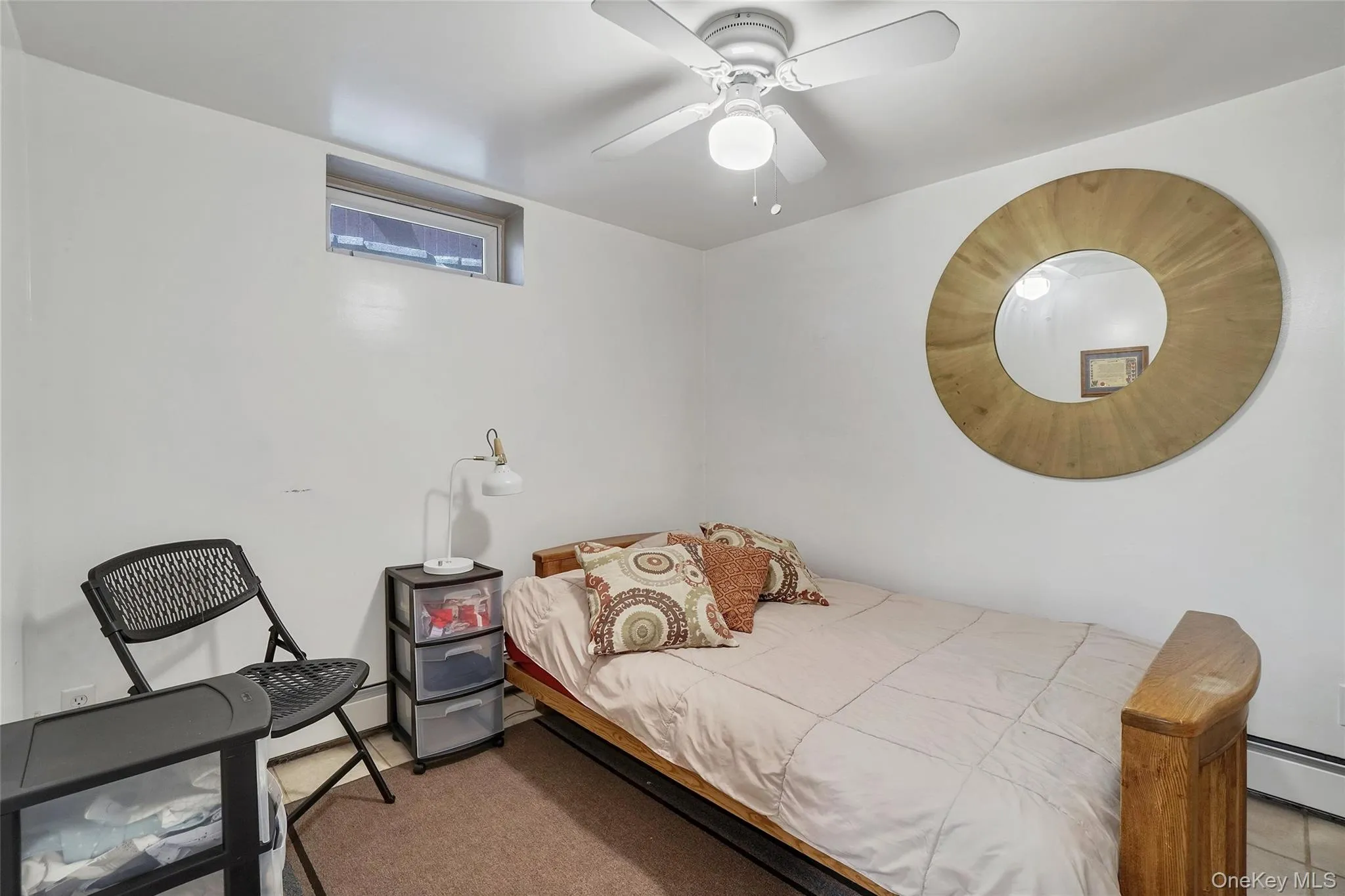 Bedroom featuring a ceiling fan and a baseboard heating unit Bedroom featuring a ceiling fan and a baseboard heating unit