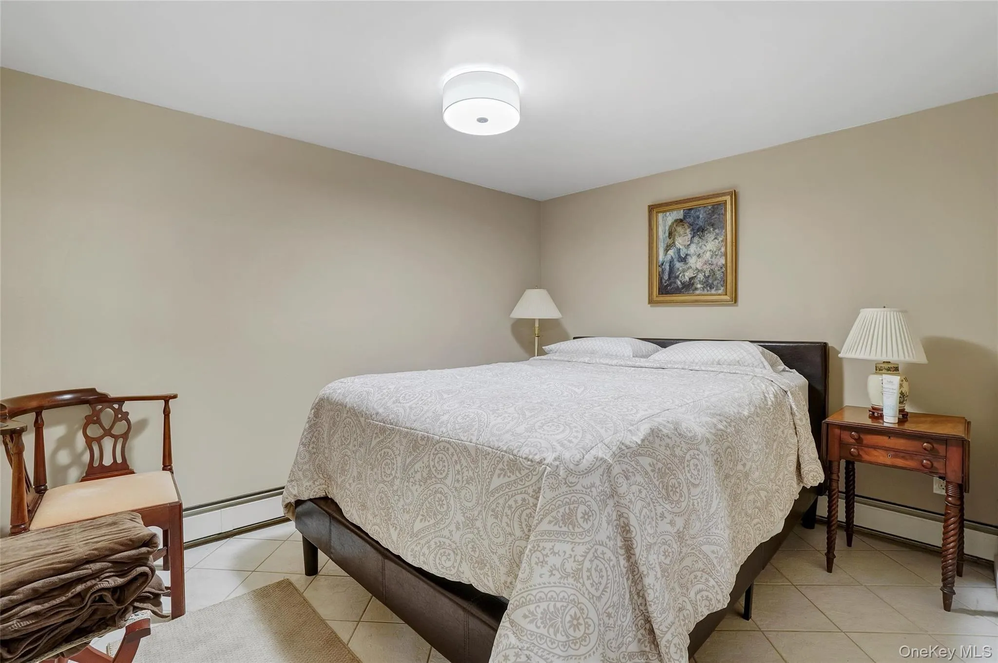 Bedroom with light tile patterned floors and a baseboard radiator Bedroom with light tile patterned floors and a baseboard radiator