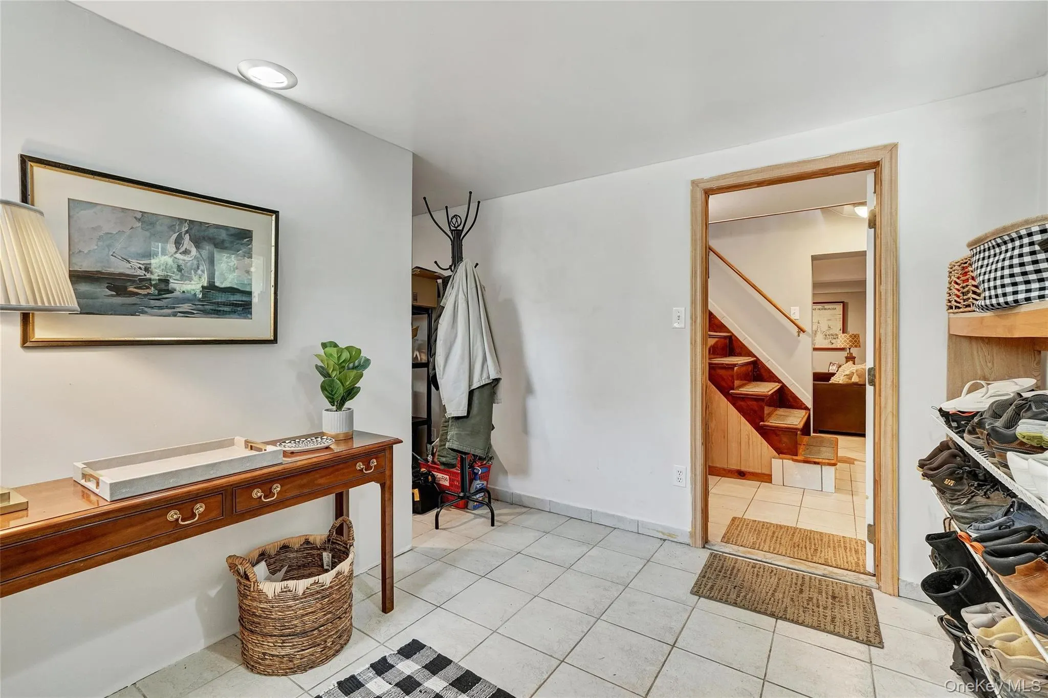 Entrance foyer with light tile patterned floors and stairway Entrance foyer with light tile patterned floors and stairway