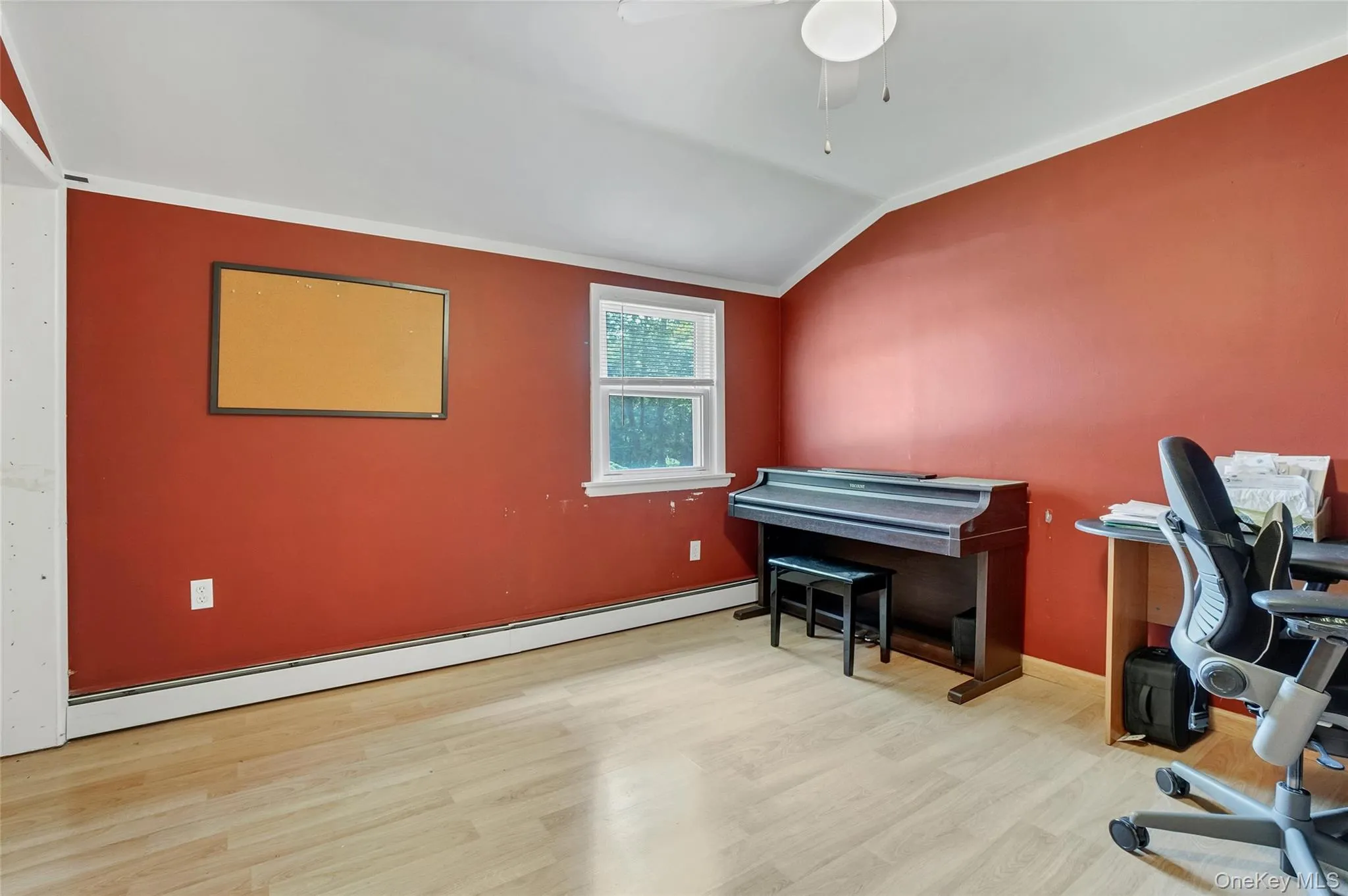 Office area with lofted ceiling, a baseboard radiator, light wood-style floors, and ceiling fan Office area with lofted ceiling, a baseboard radiator, light wood-style floors, and ceiling fan