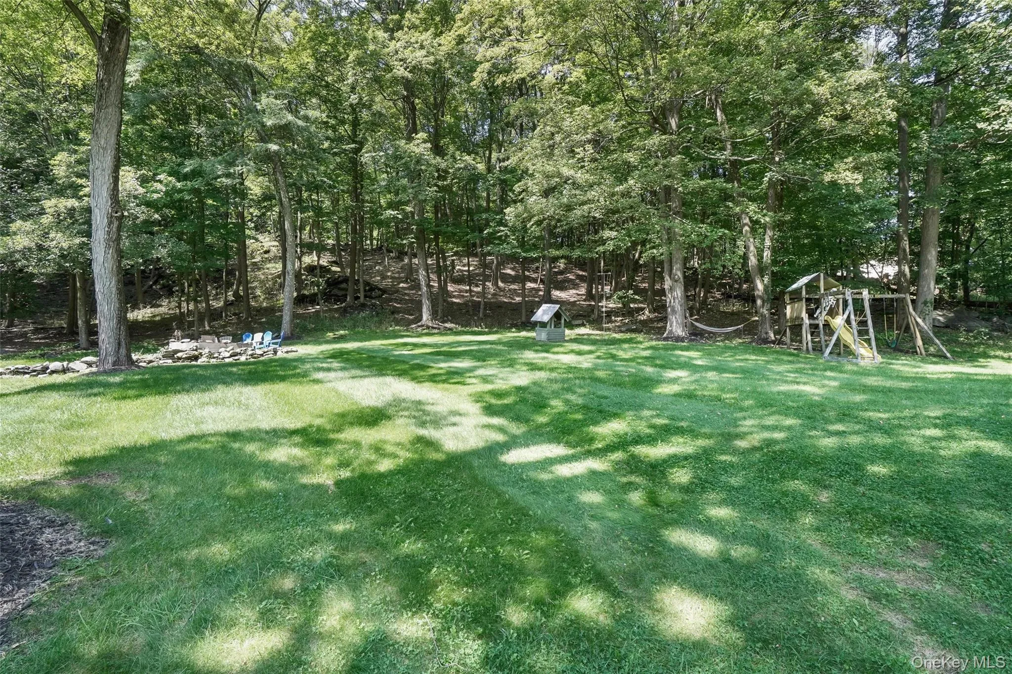 View of green lawn with a playground View of green lawn with a playground
