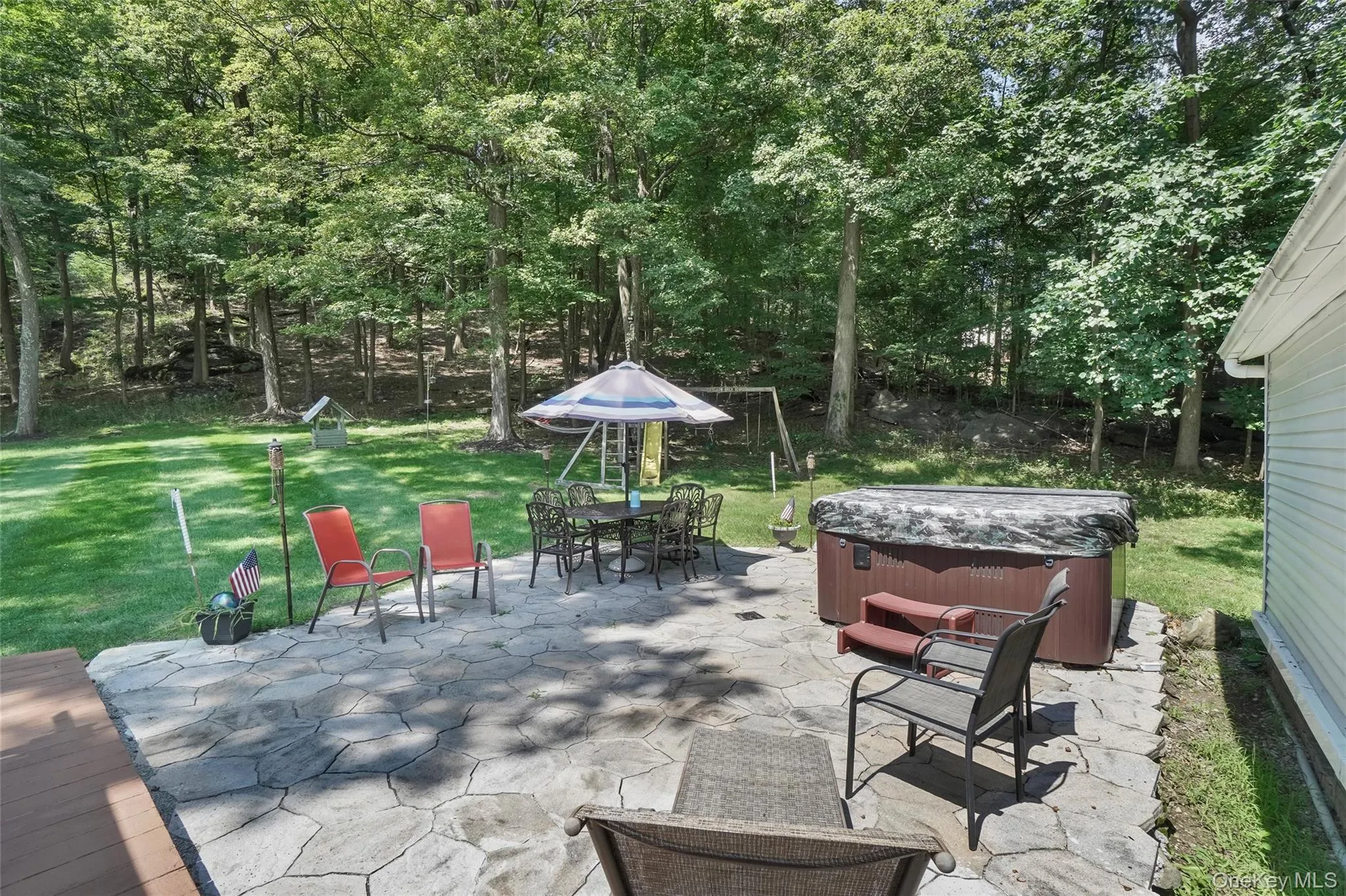View of patio / terrace with a hot tub and outdoor dining space View of patio / terrace with a hot tub and outdoor dining space