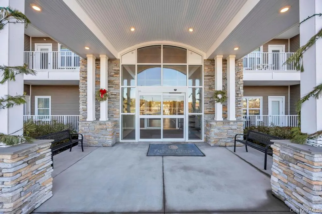 Doorway to property with stone siding and a patio Doorway to property with stone siding and a patio