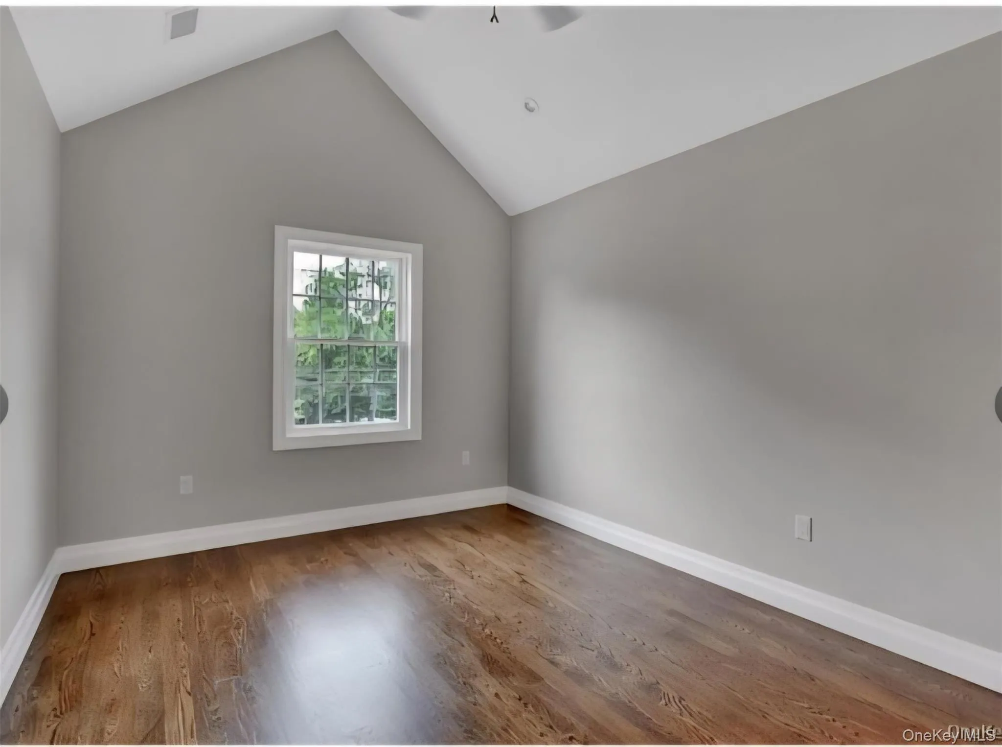 Bonus room with vaulted ceiling, a ceiling fan, and wood finished floors Bonus room with vaulted ceiling, a ceiling fan, and wood finished floors