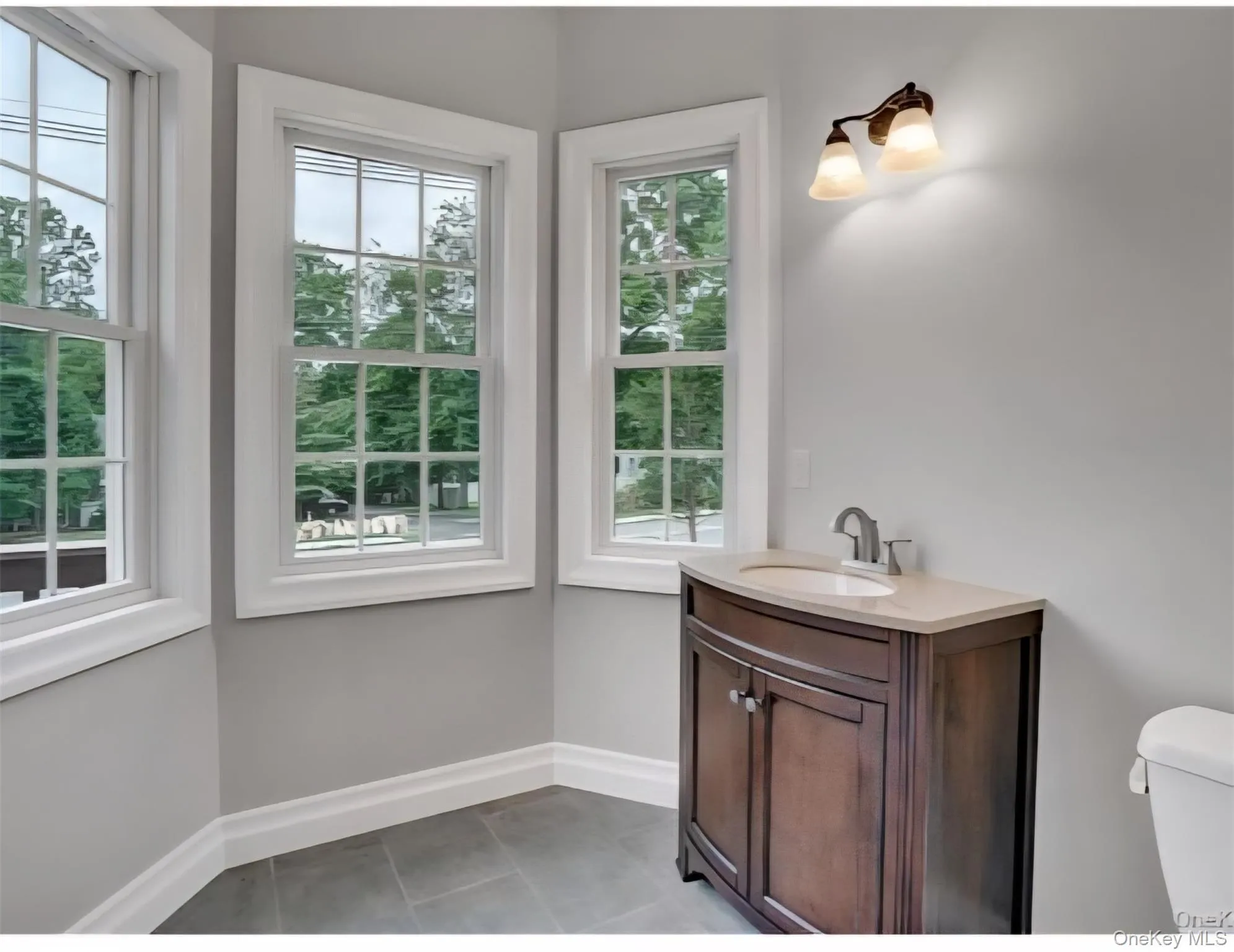 Half bathroom with vanity and healthy amount of natural light Half bathroom with vanity and healthy amount of natural light
