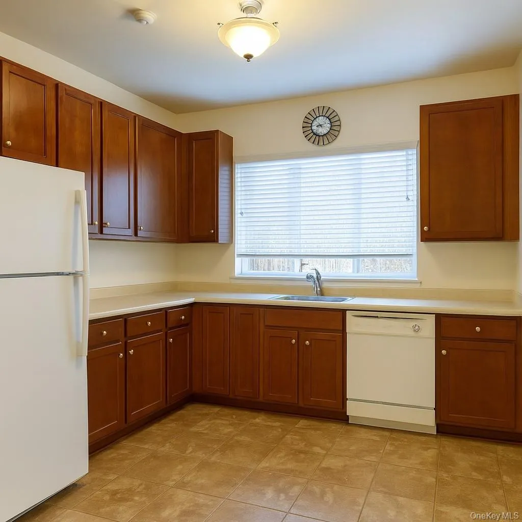 A spacious eat in kitchen with wood cabinets, a ceramic tile floor - new stainless steel refrigerator, gas range and dishwasher and silver cabinet pulls will be installed. A spacious eat in kitchen with wood cabinets, a ceramic tile floor - new stainless steel refrigerator, gas range and dishwasher and silver cabinet pulls will be installed.