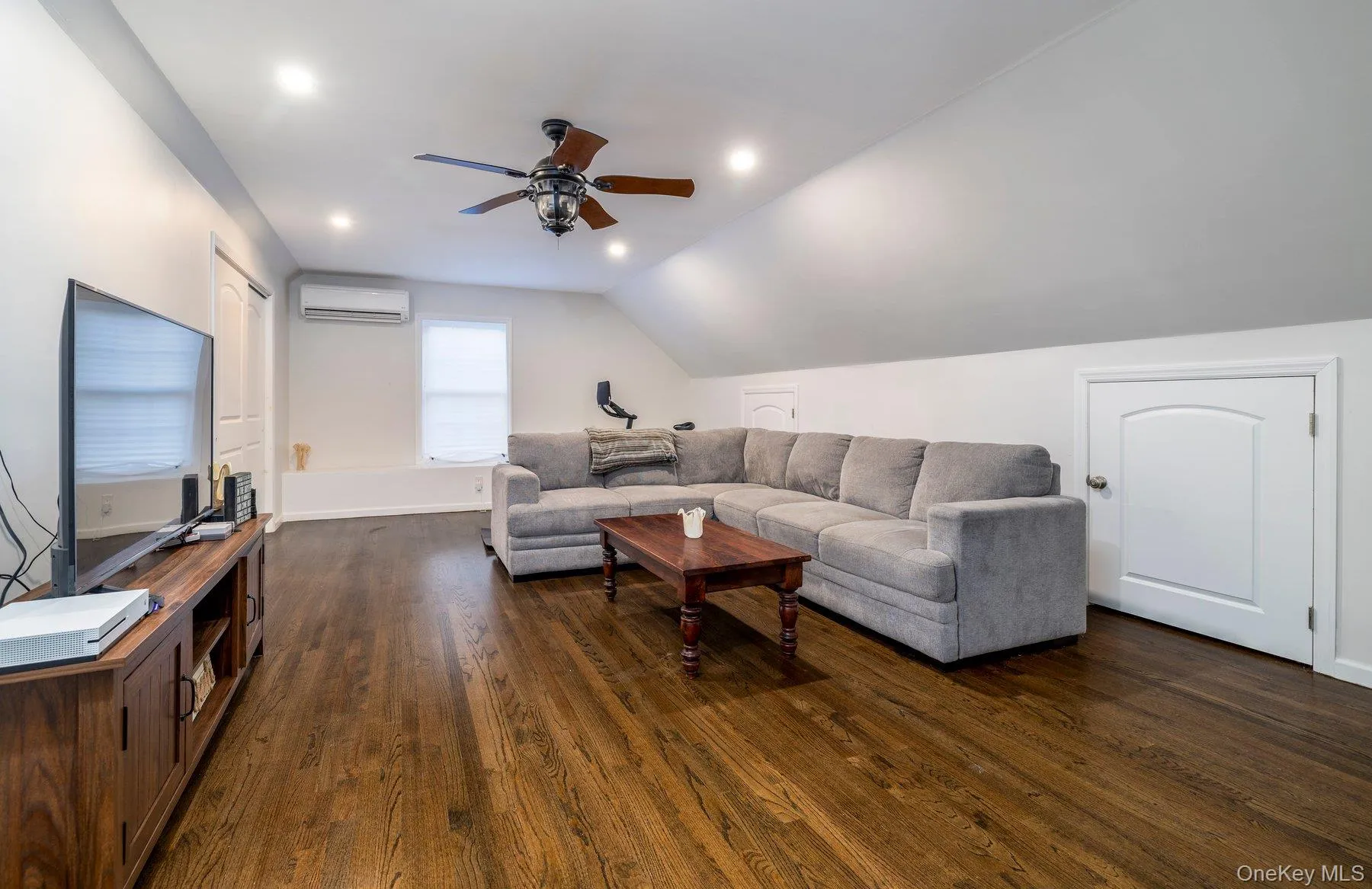 Bonus room featuring dark wood-style flooring, recessed lighting, a wall mounted AC, vaulted ceiling, and a ceiling fan Bonus room featuring dark wood-style flooring, recessed lighting, a wall mounted AC, vaulted ceiling, and a ceiling fan