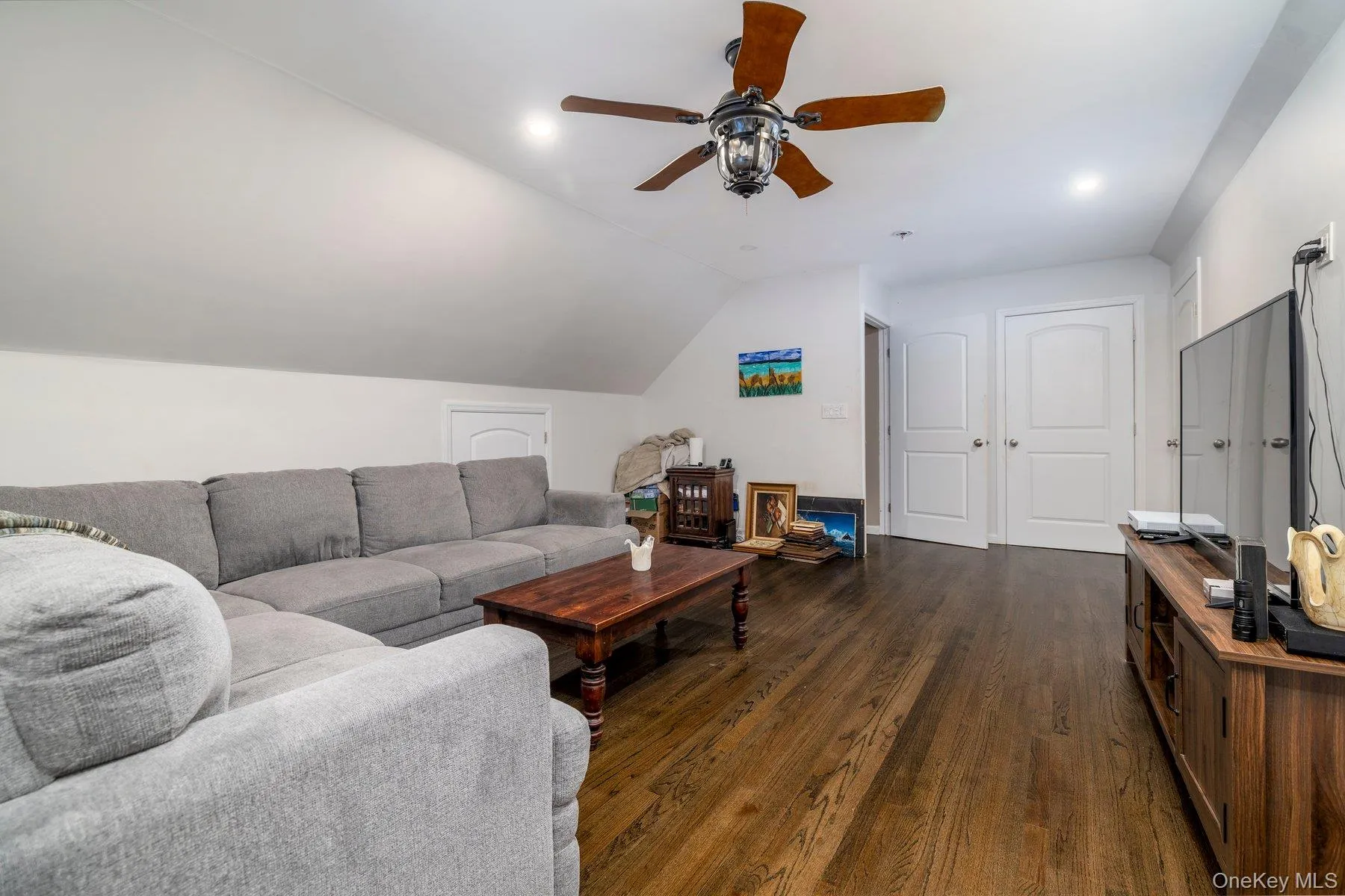Bonus room featuring vaulted ceiling, dark wood finished floors, and a ceiling fan Bonus room featuring vaulted ceiling, dark wood finished floors, and a ceiling fan