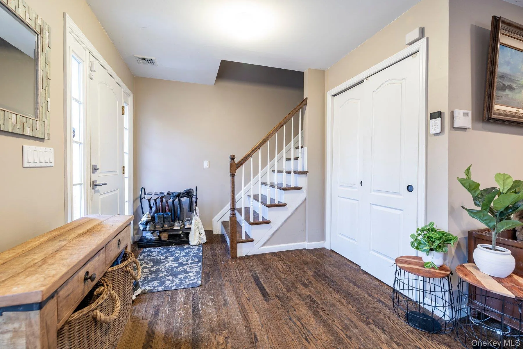 Foyer featuring stairs and dark wood-style flooring Foyer featuring stairs and dark wood-style flooring