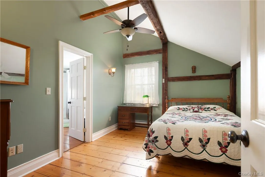 ceiling fan, vaulted ceiling with beams, and light hardwood floors ceiling fan, vaulted ceiling with beams, and light hardwood floors