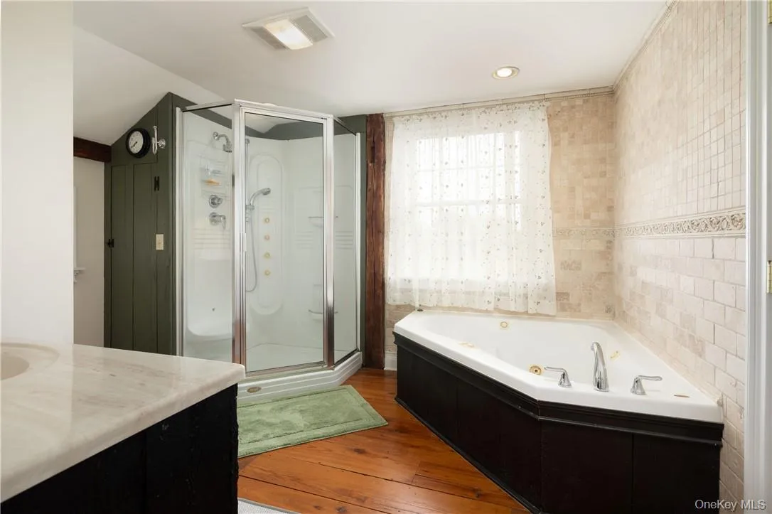 wood flooring, vanity,, and independent shower and jacuzzi wood flooring, vanity,, and independent shower and jacuzzi