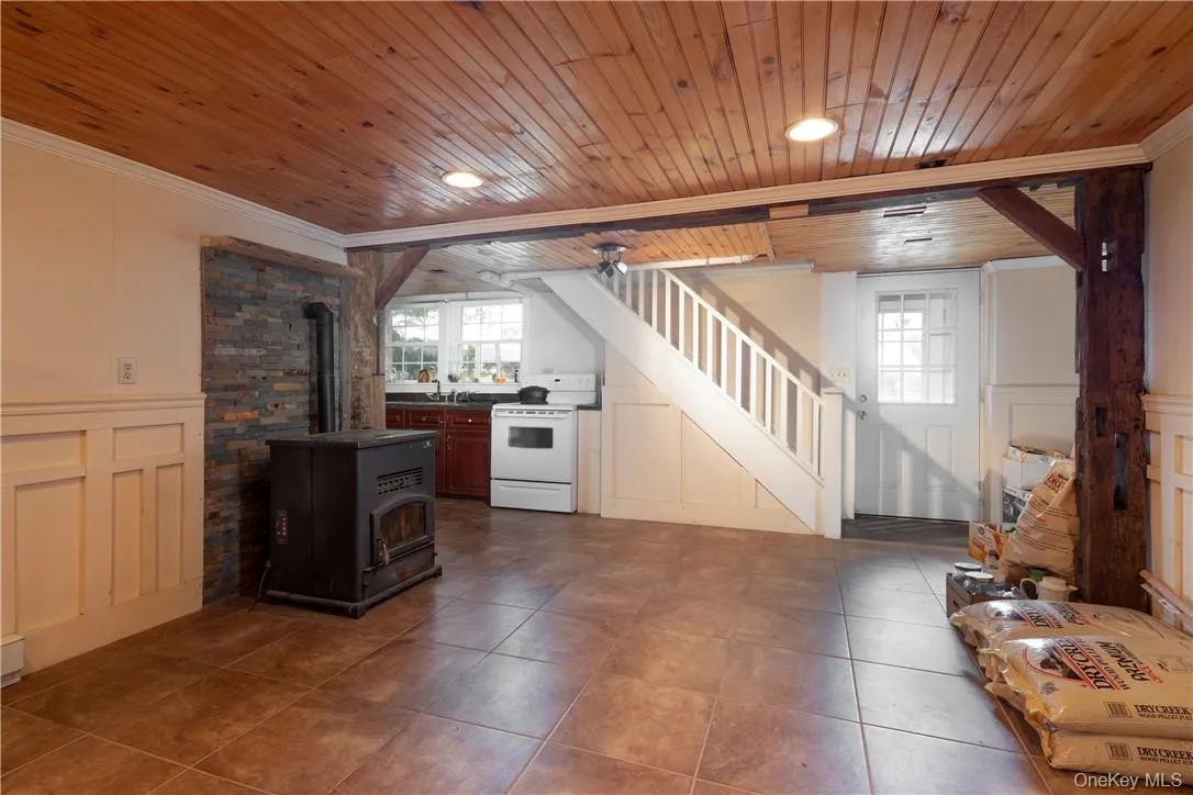 Laminate flooring. mini kitchen, wood ceiling, beam ceiling, and a pellet stove Laminate flooring. mini kitchen, wood ceiling, beam ceiling, and a pellet stove