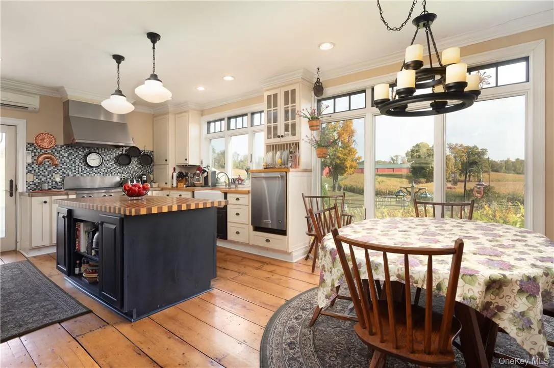 Kitchen with butcher block counters, a healthy amount of sunlight Kitchen with butcher block counters, a healthy amount of sunlight