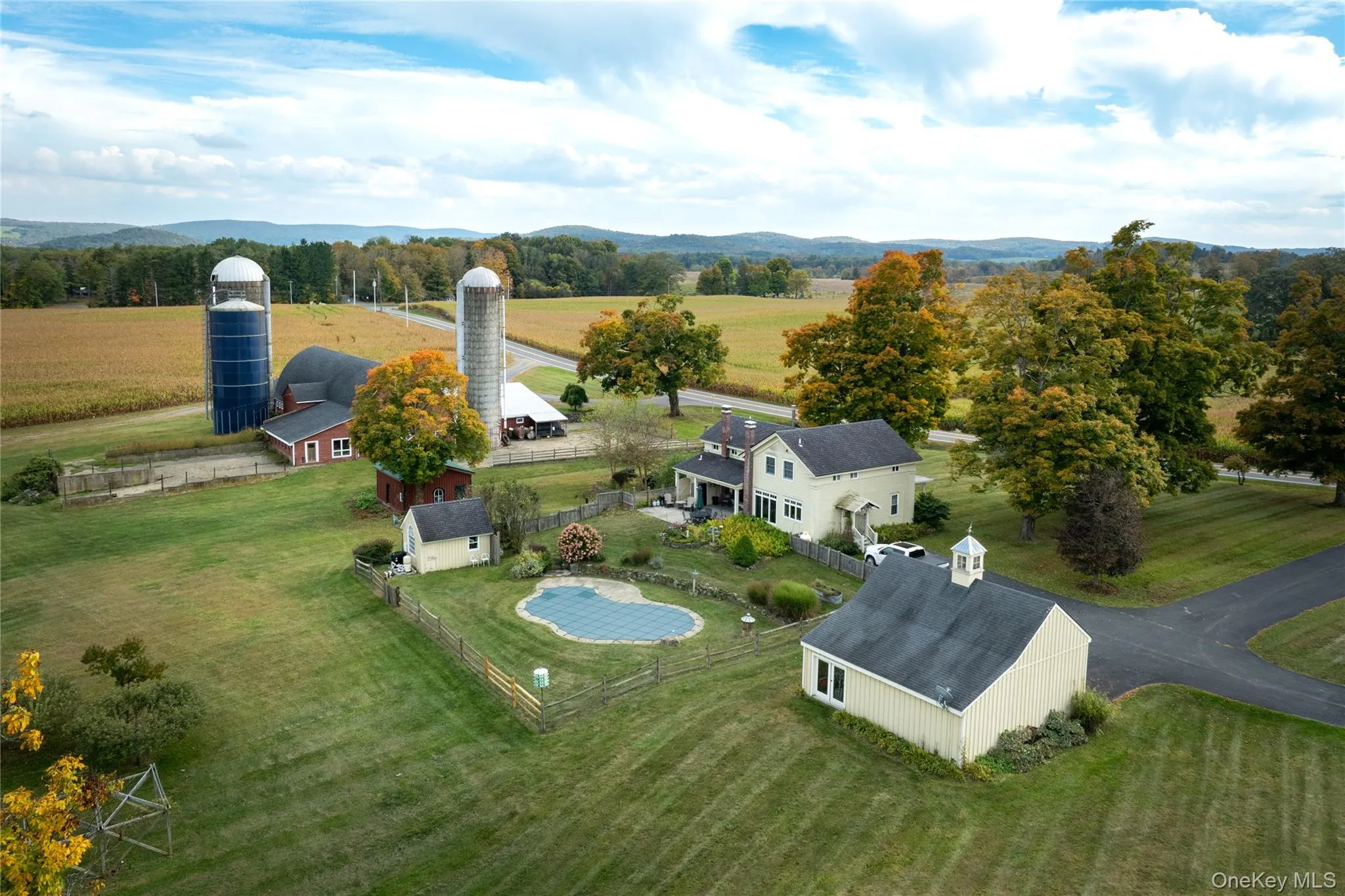 Close up of back of farm with barns, main house, pool area Close up of back of farm with barns, main house, pool area