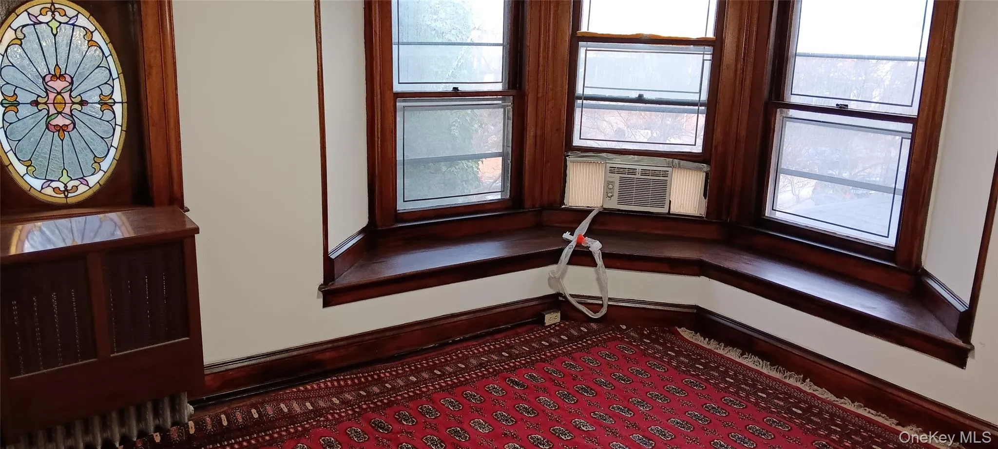 Bedroom with stain glass window in addition to 3 bay windows. Bedroom with stain glass window in addition to 3 bay windows.