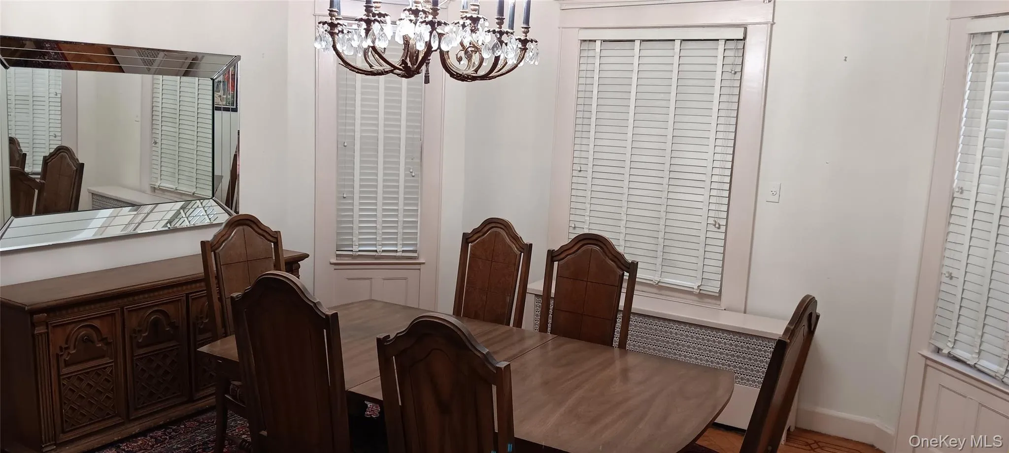 Dining room with a chandelier and wood finished floors Dining room with a chandelier and wood finished floors