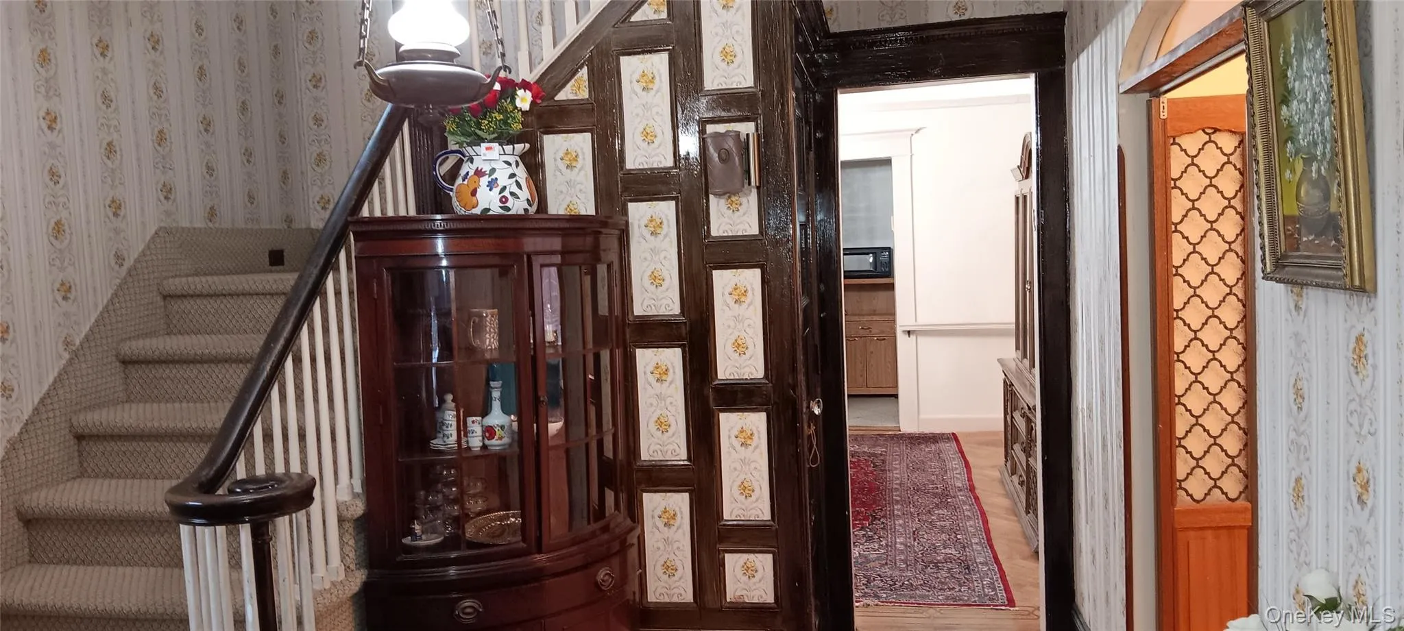 Staircase featuring wallpapered walls Staircase featuring wallpapered walls