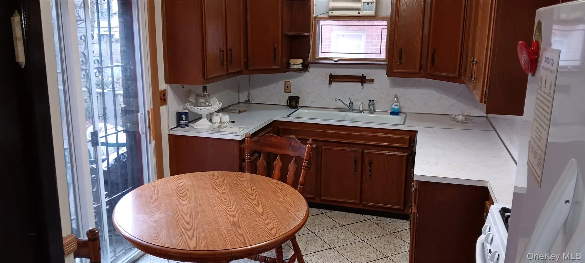 Kitchen with light countertops, open shelves, and white appliances Kitchen with light countertops, open shelves, and white appliances