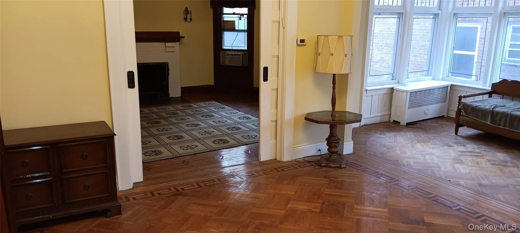 Corridor featuring radiator and parquet floors Corridor featuring radiator and parquet floors