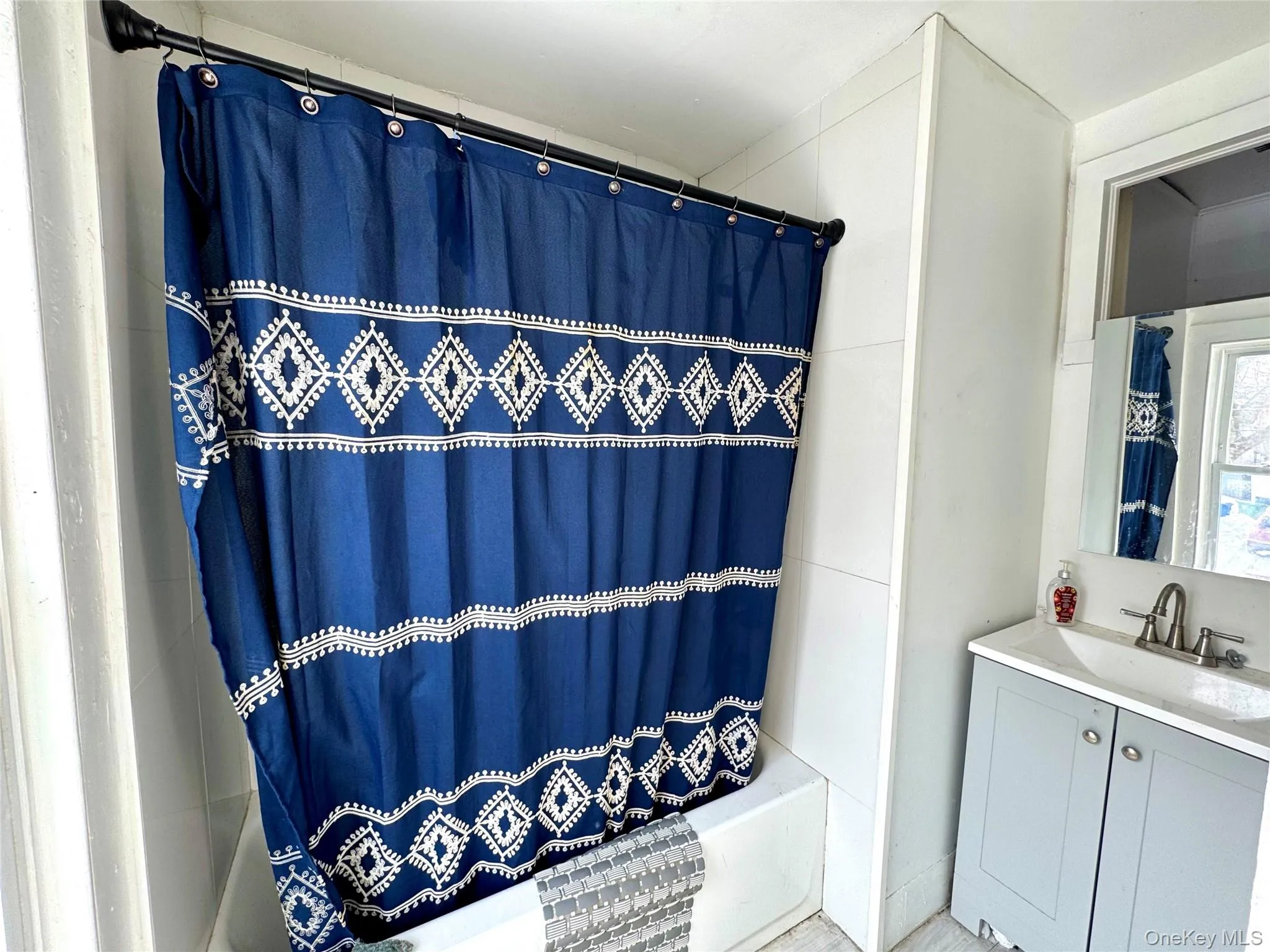 Bathroom with shower / bath combo and vanity Bathroom with shower / bath combo and vanity