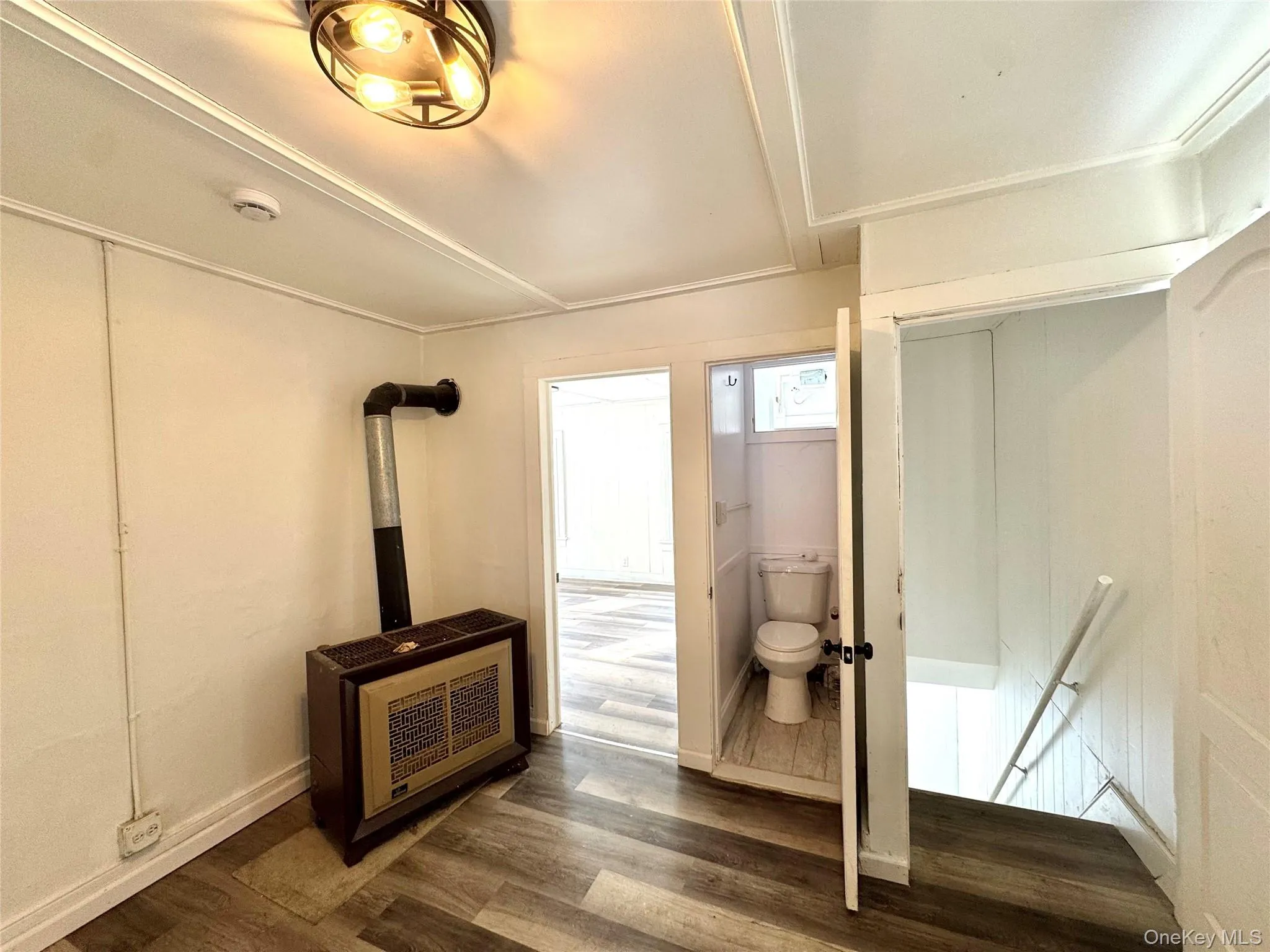 Bathroom with wood finished floors and heating unit Bathroom with wood finished floors and heating unit