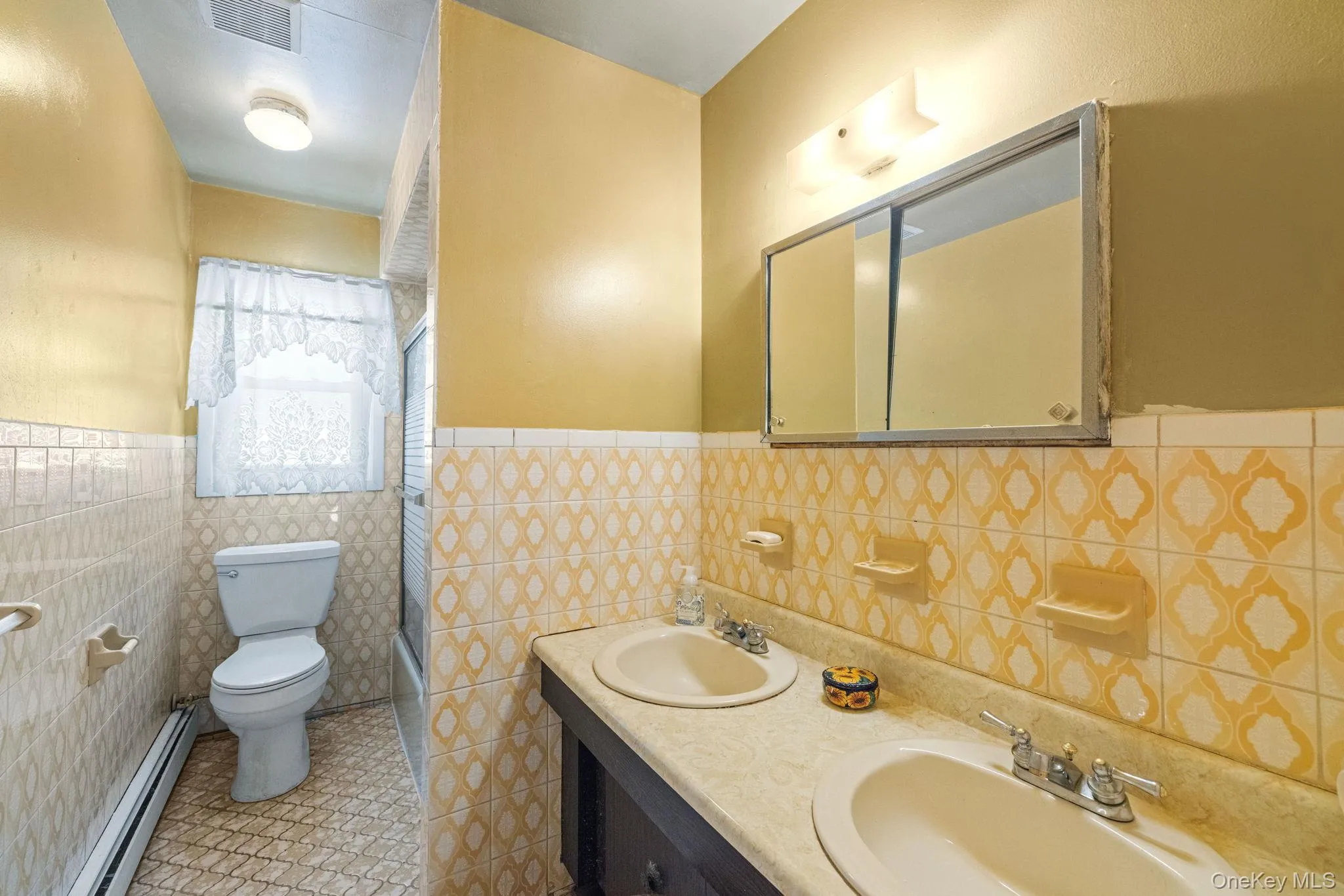 Hallway full bath with tub and double sinks Hallway full bath with tub and double sinks