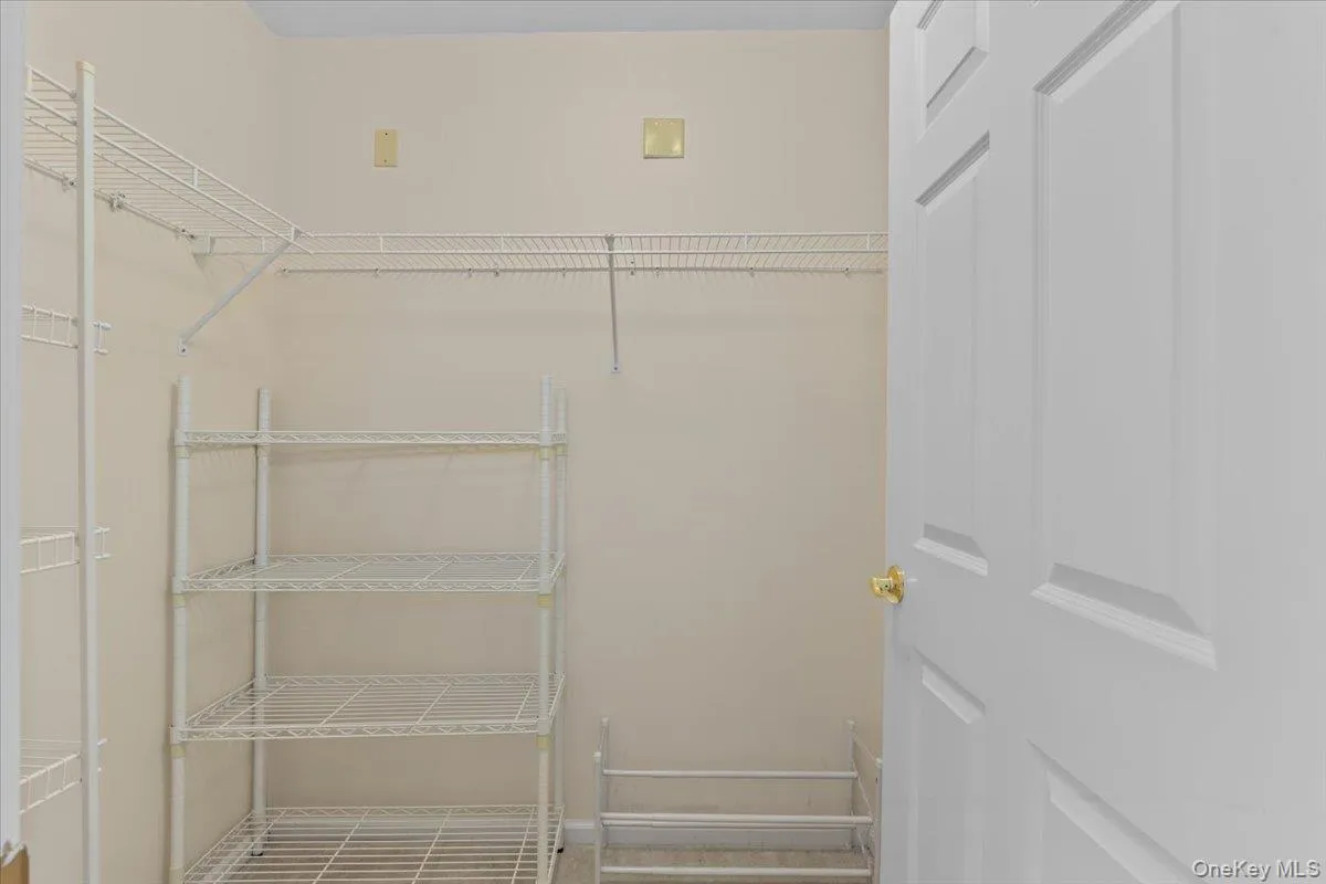 walk-in closet in primary bedroom walk-in closet in primary bedroom