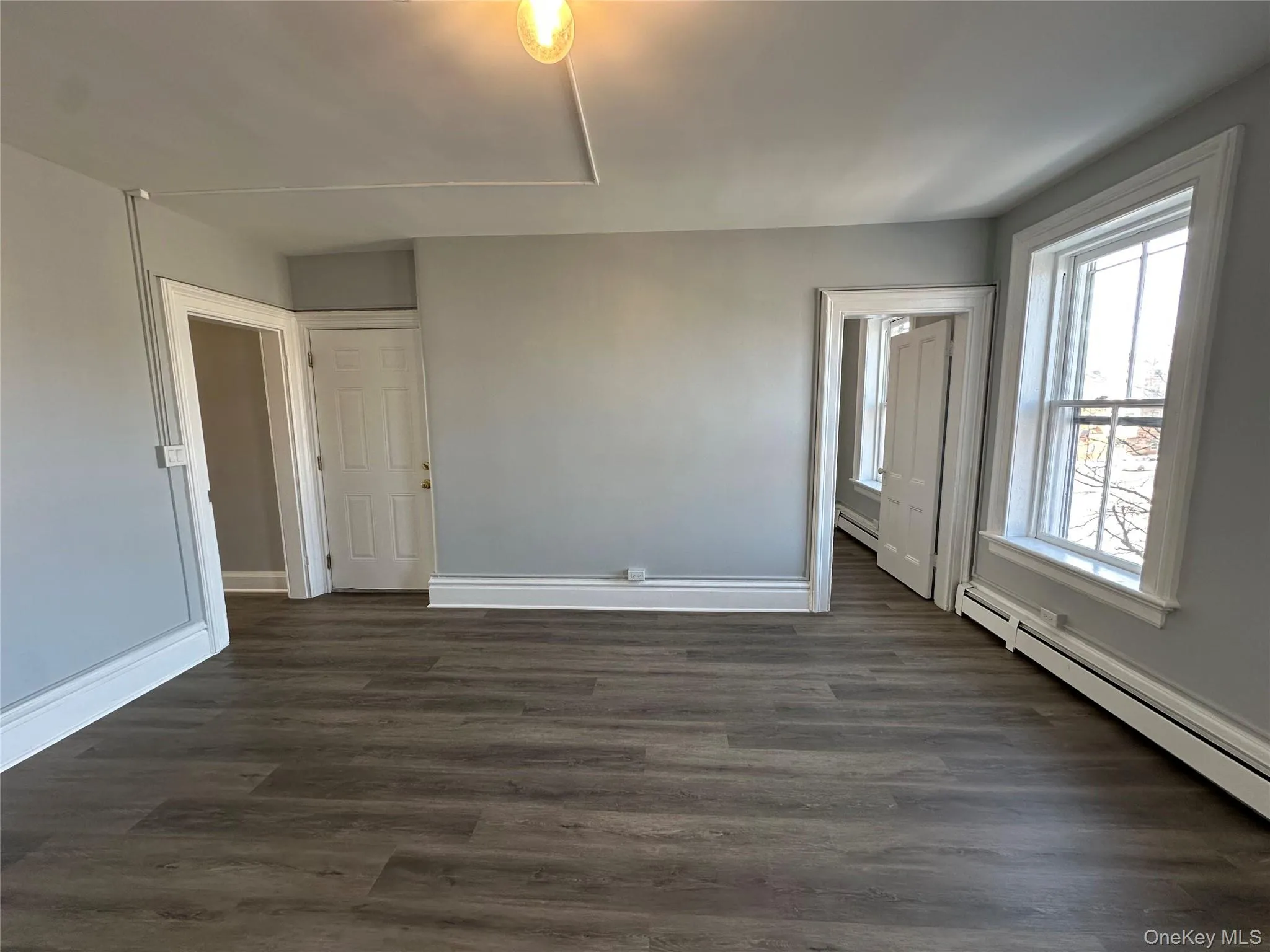 Living Room w/ Big Windows & Luxury Vinyl Plank Flooring Living Room w/ Big Windows & Luxury Vinyl Plank Flooring