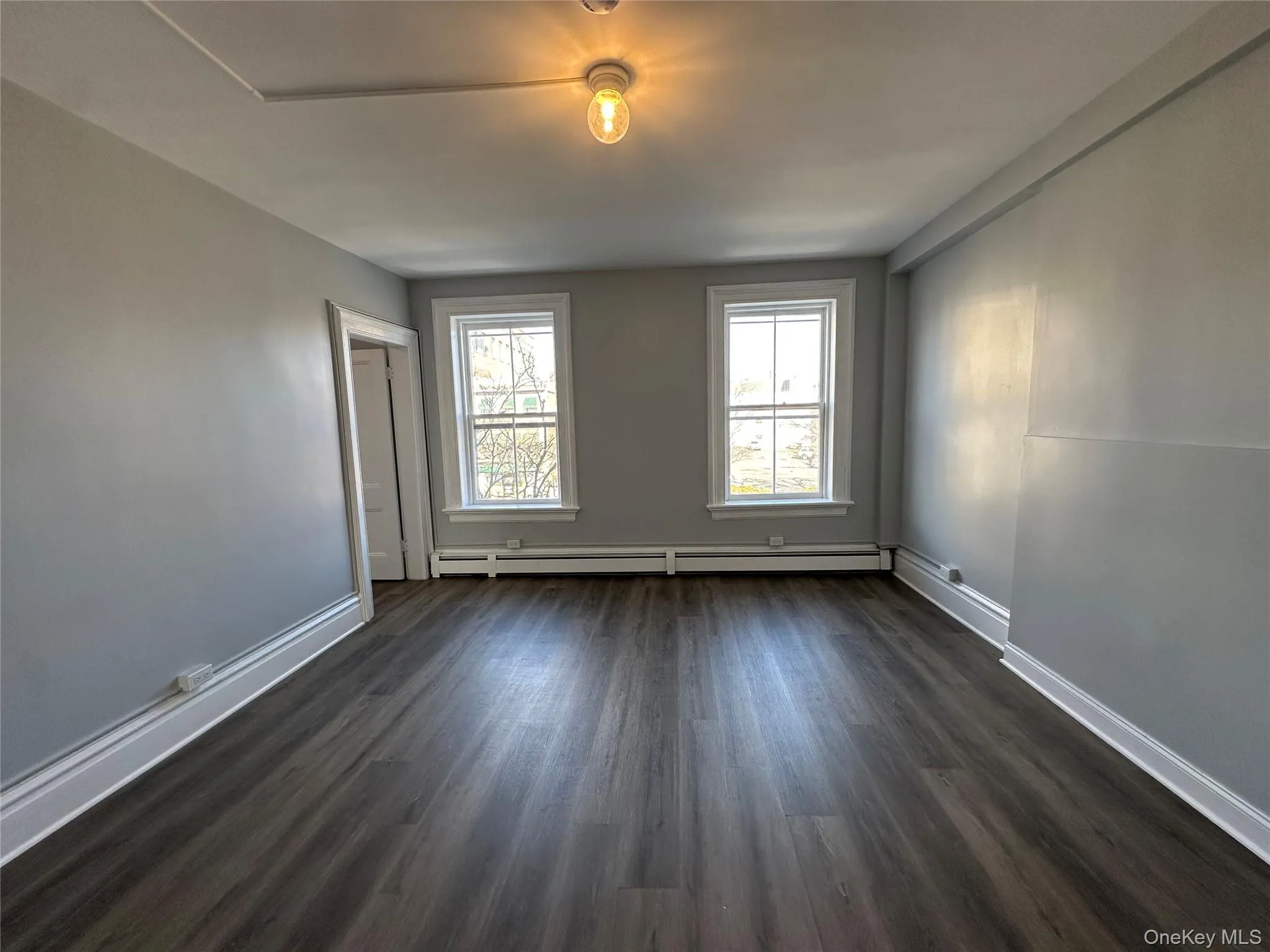Living Room w/ Big Windows & Luxury Vinyl Plank Flooring Living Room w/ Big Windows & Luxury Vinyl Plank Flooring